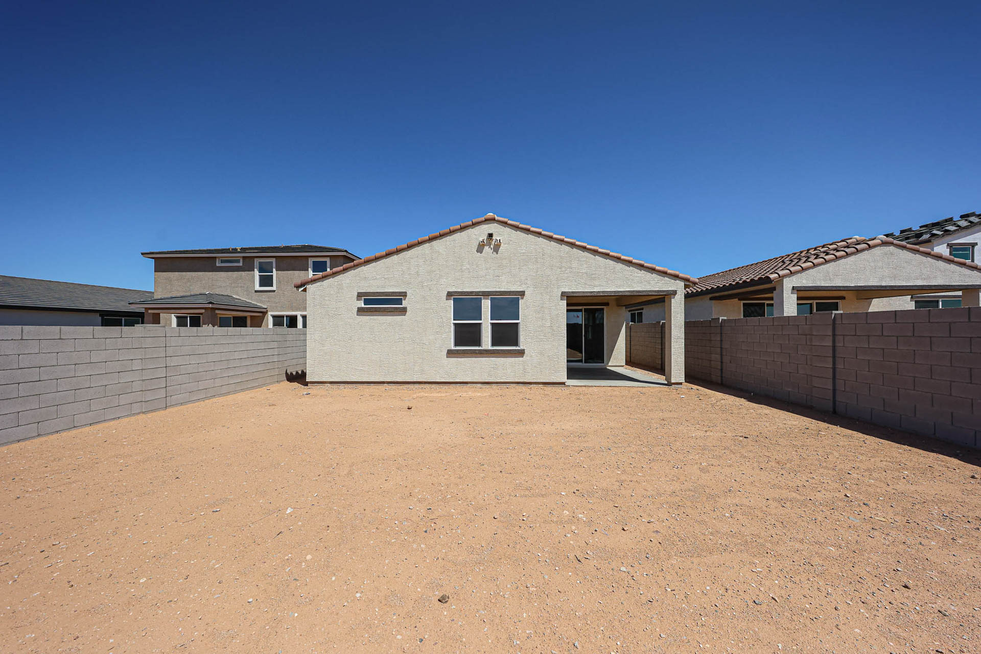 A building with a dirt yard.