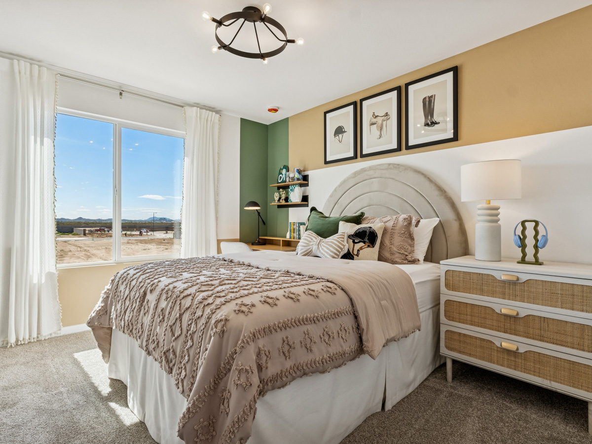 A bedroom with a large window.