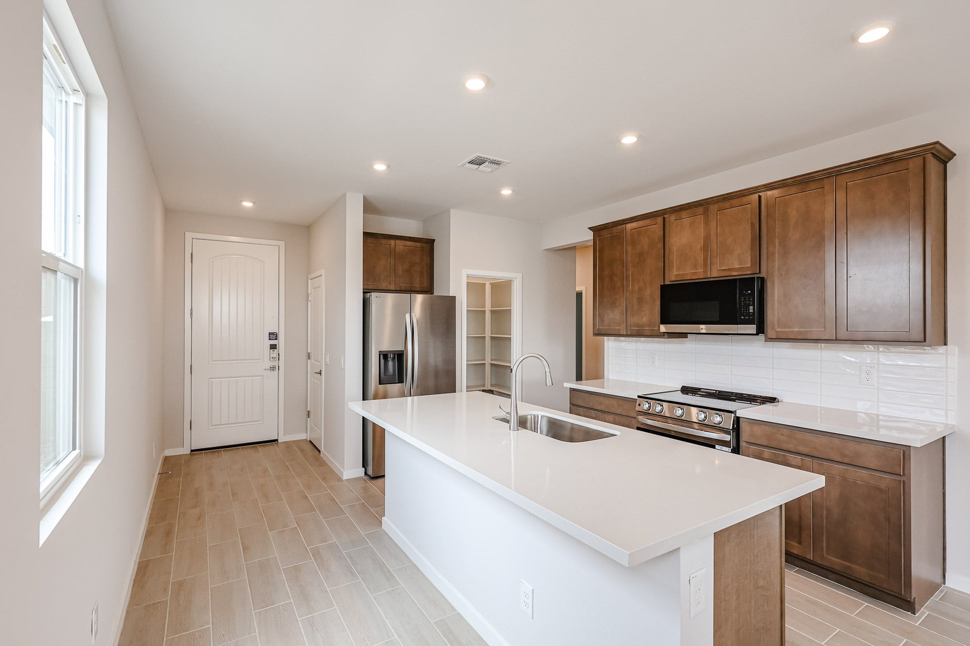 A kitchen with wooden cabinets.