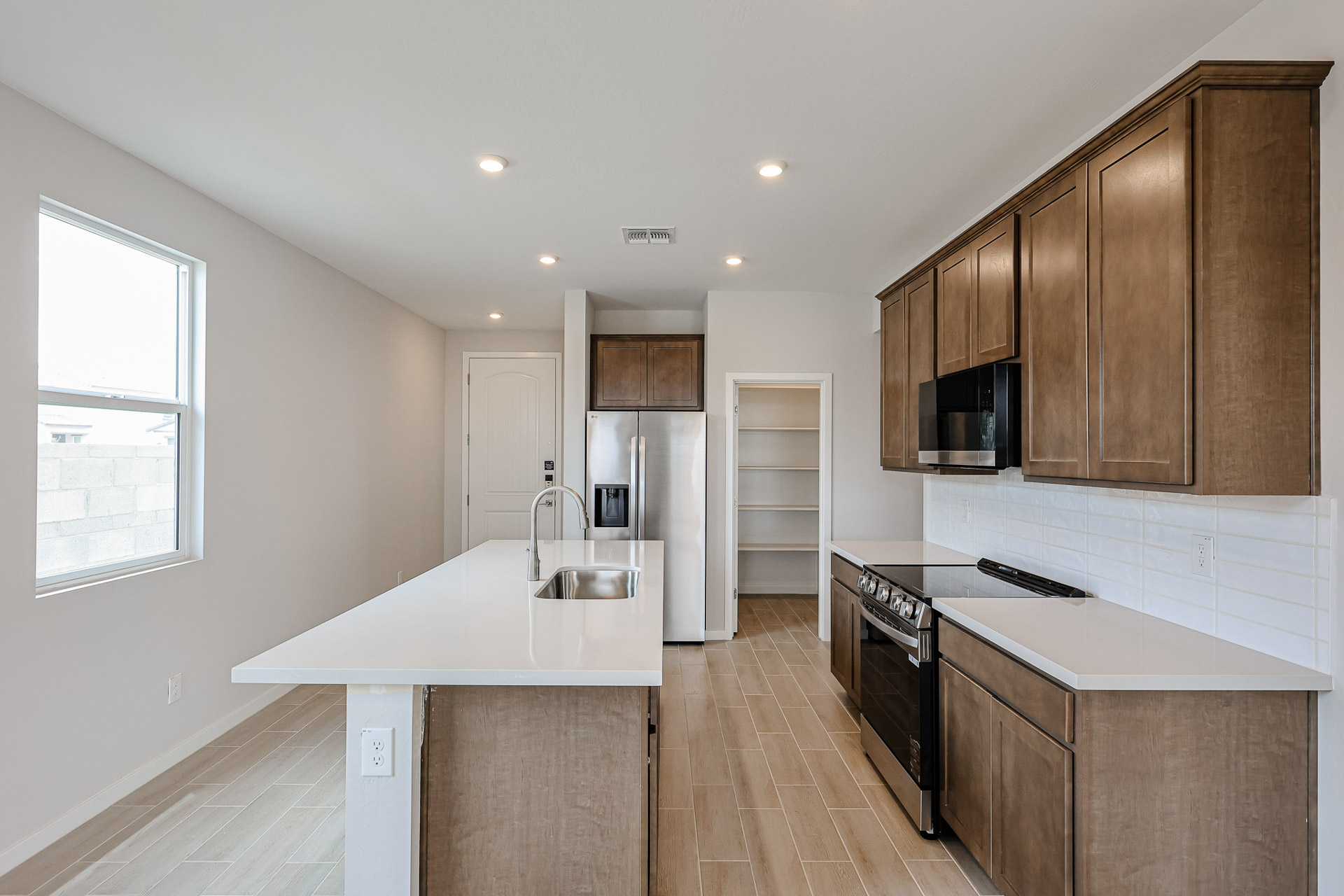 A kitchen with wooden cabinets.
