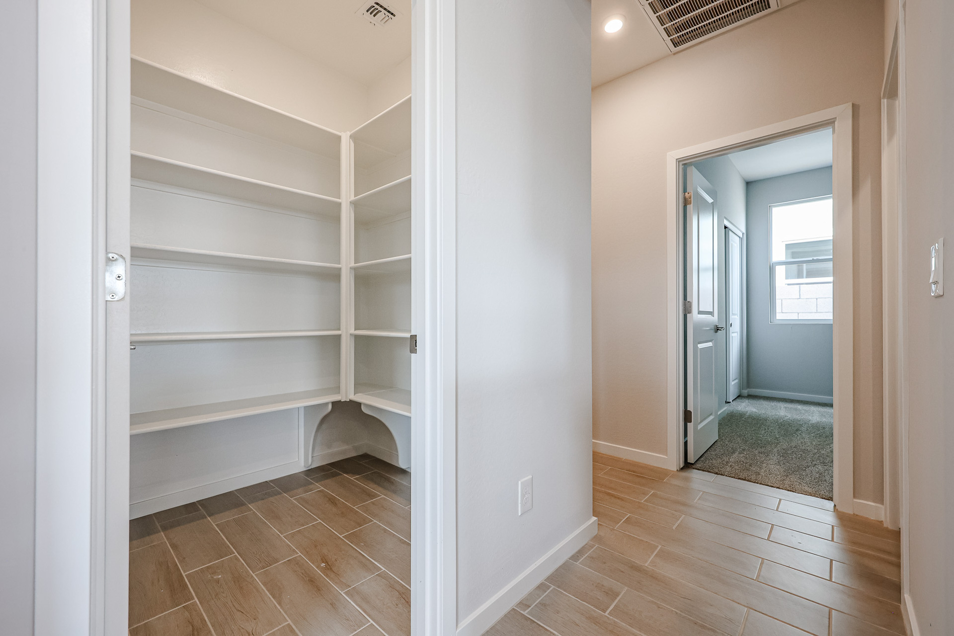A room with a wood floor and white walls.