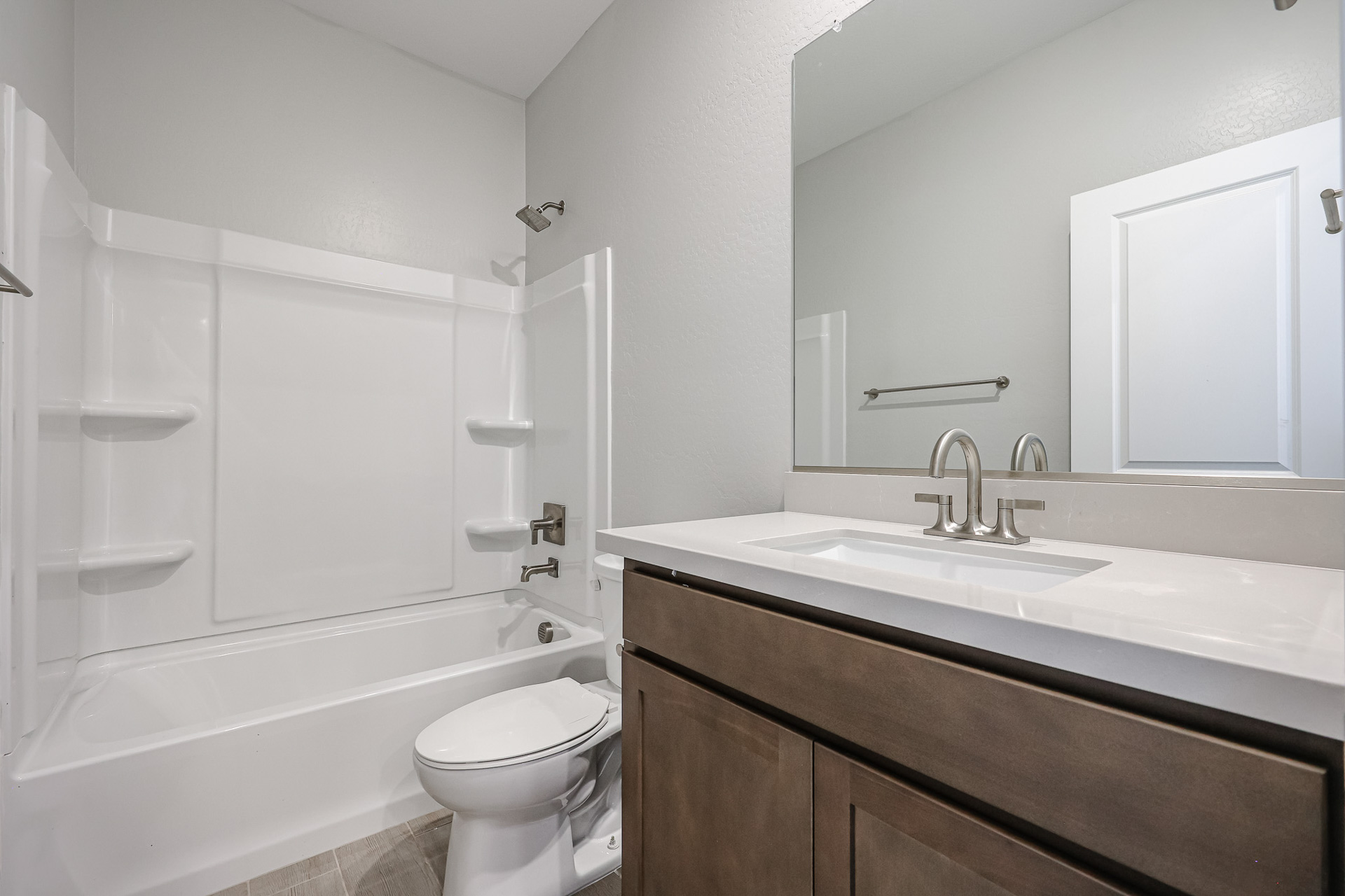 A bathroom with a tub sink and toilet.