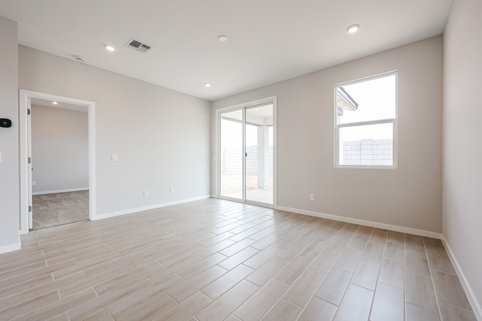 A room with a wood floor and white walls.