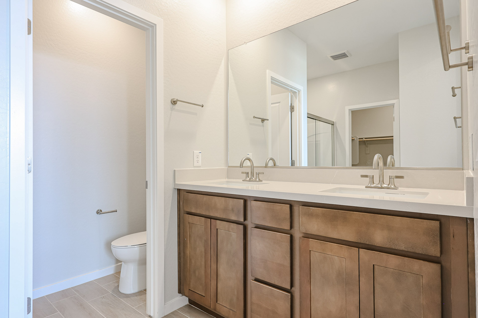 A bathroom with a large mirror.