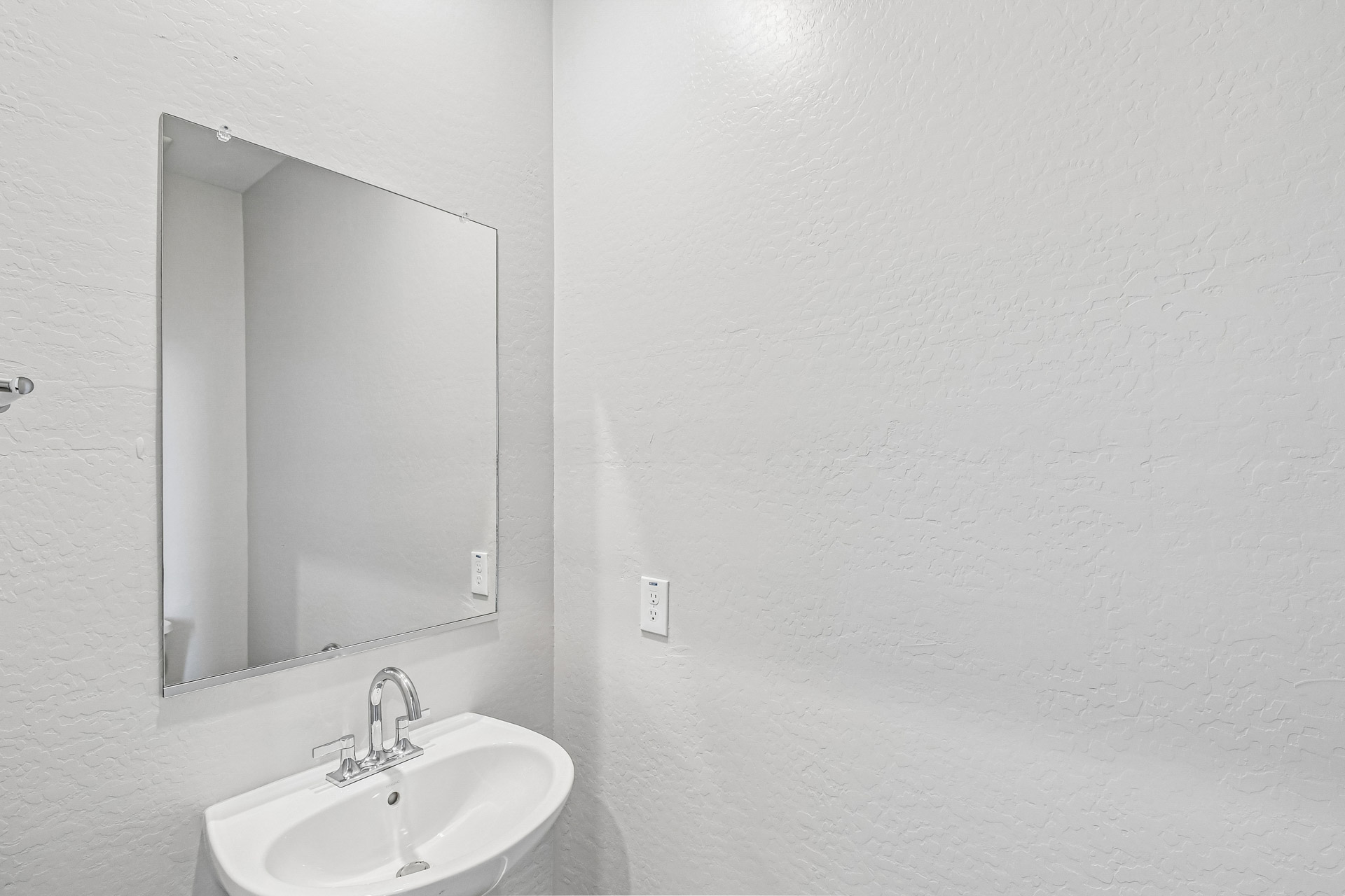 A bathroom with a mirror.