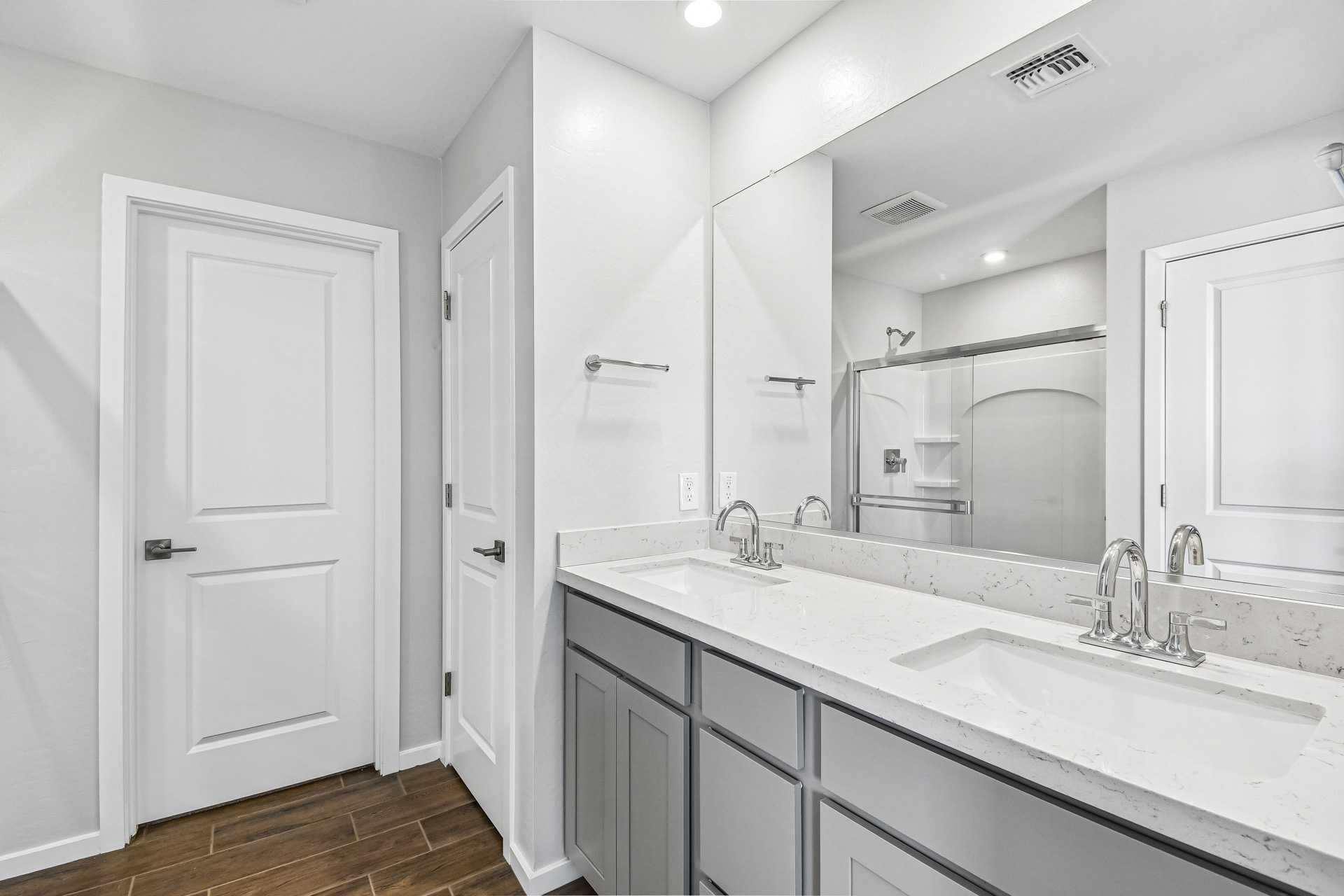 A bathroom with white cabinets.