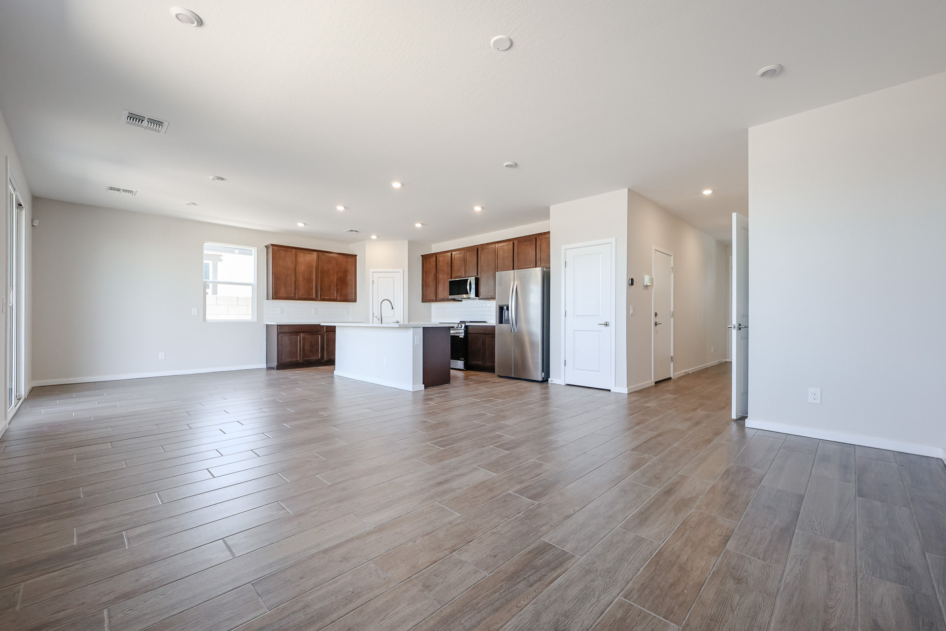 A large kitchen with wood floors.