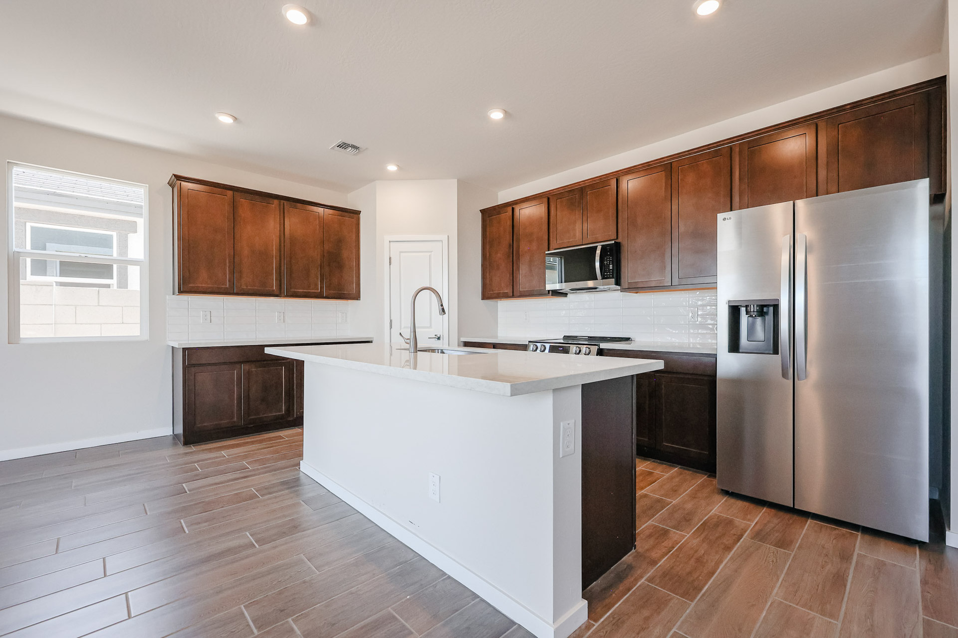 A kitchen with wooden cabinets.