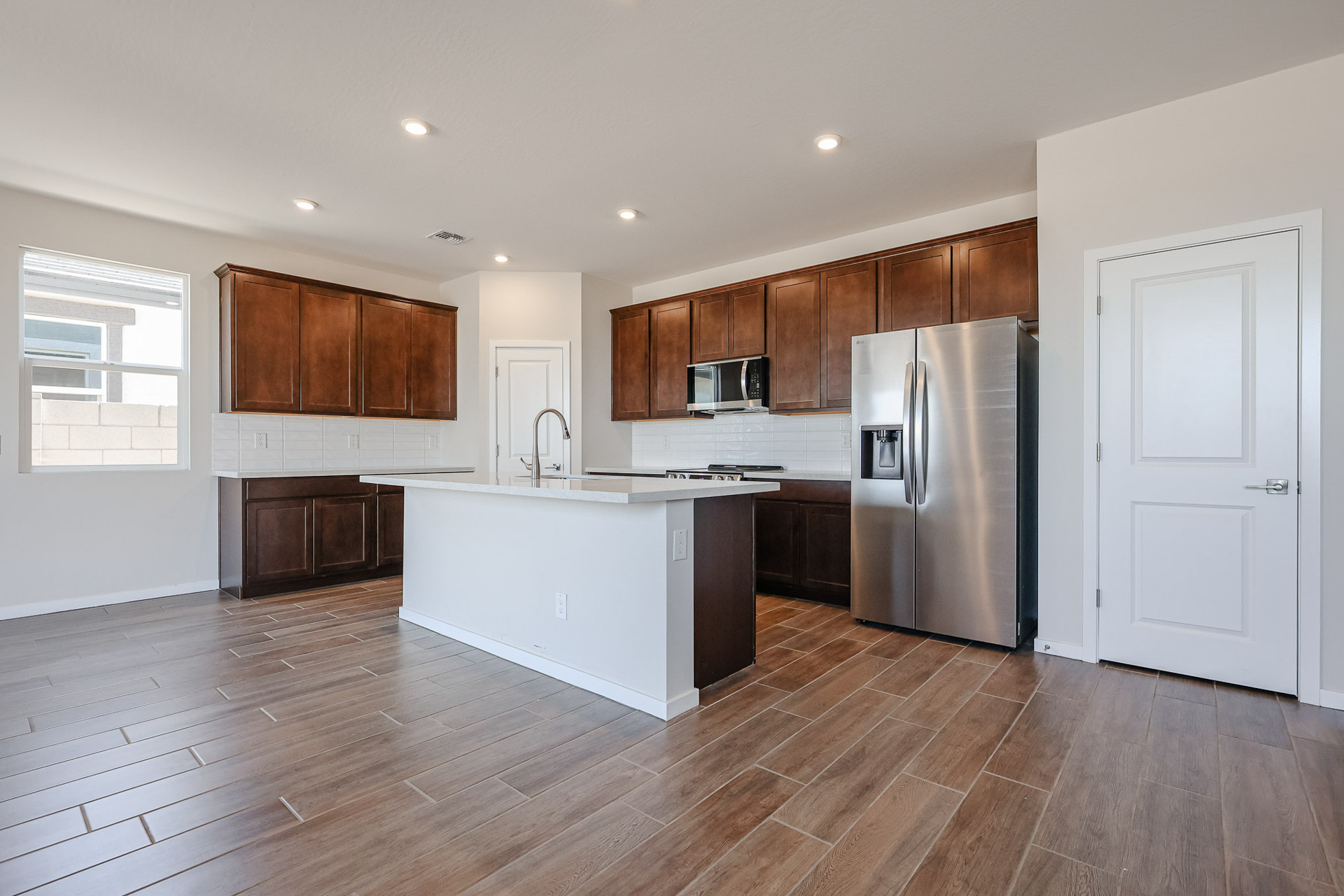 A kitchen with wooden cabinets.