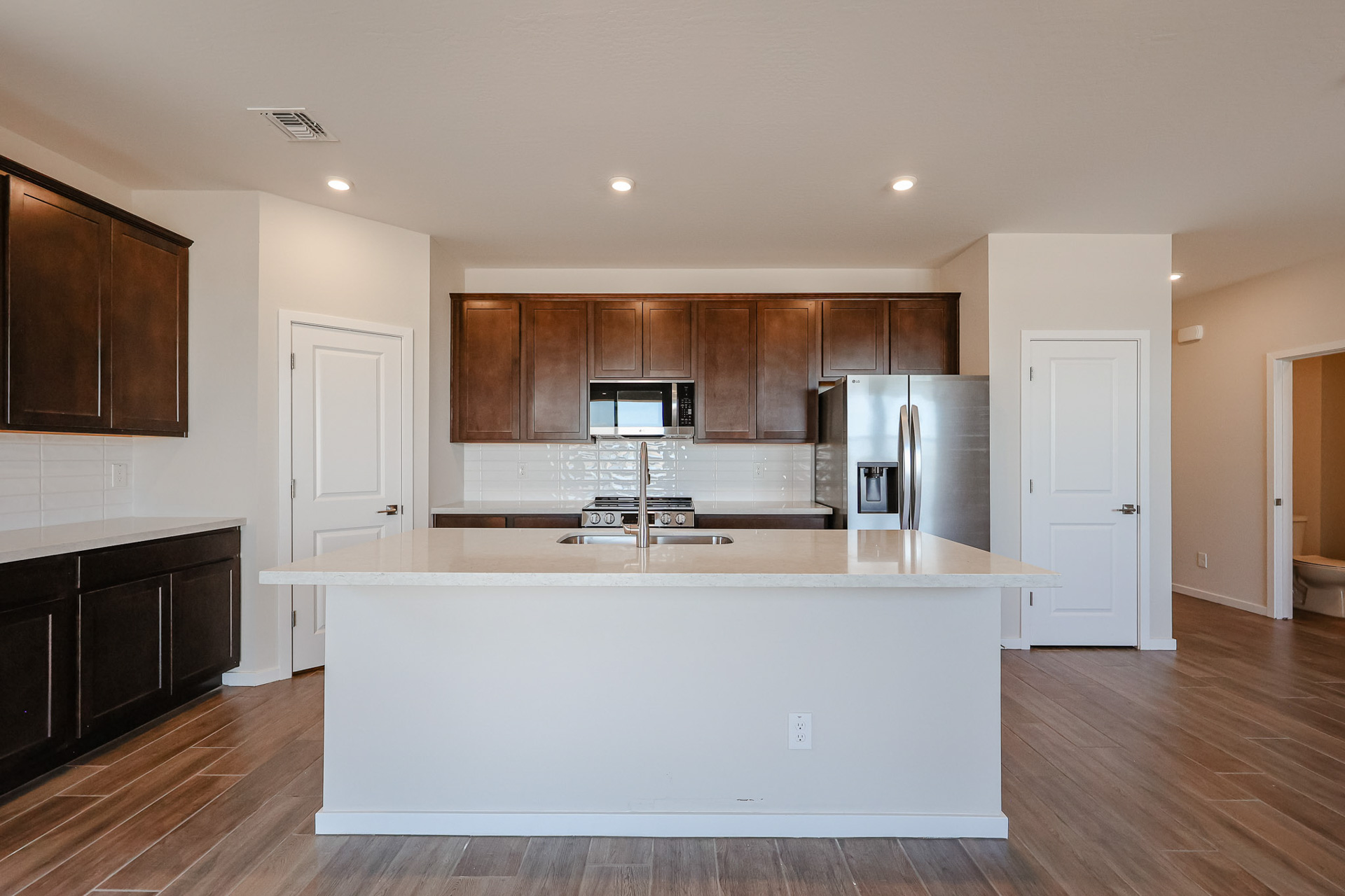 A kitchen with wooden cabinets.