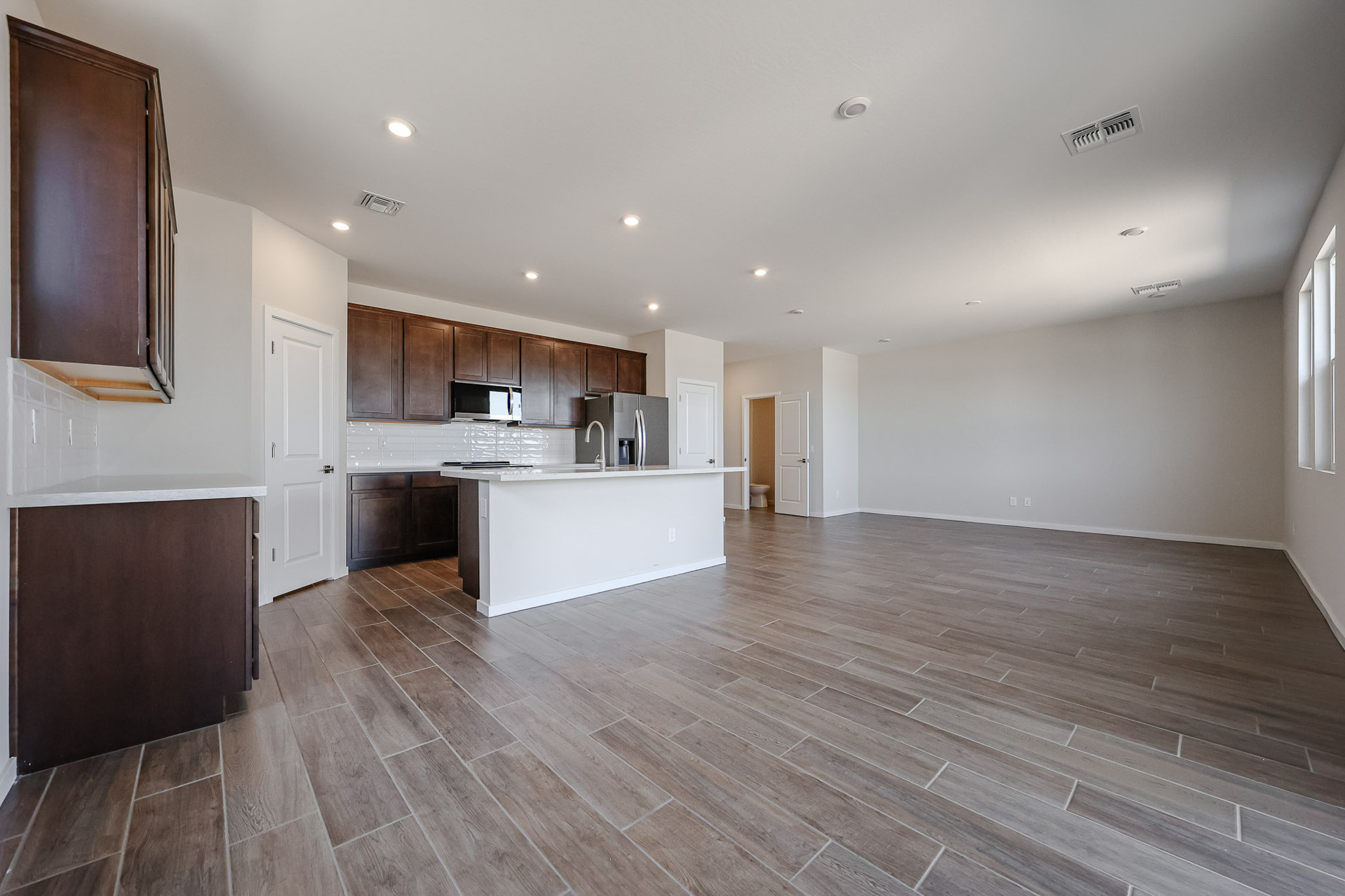A large kitchen with wooden floors.