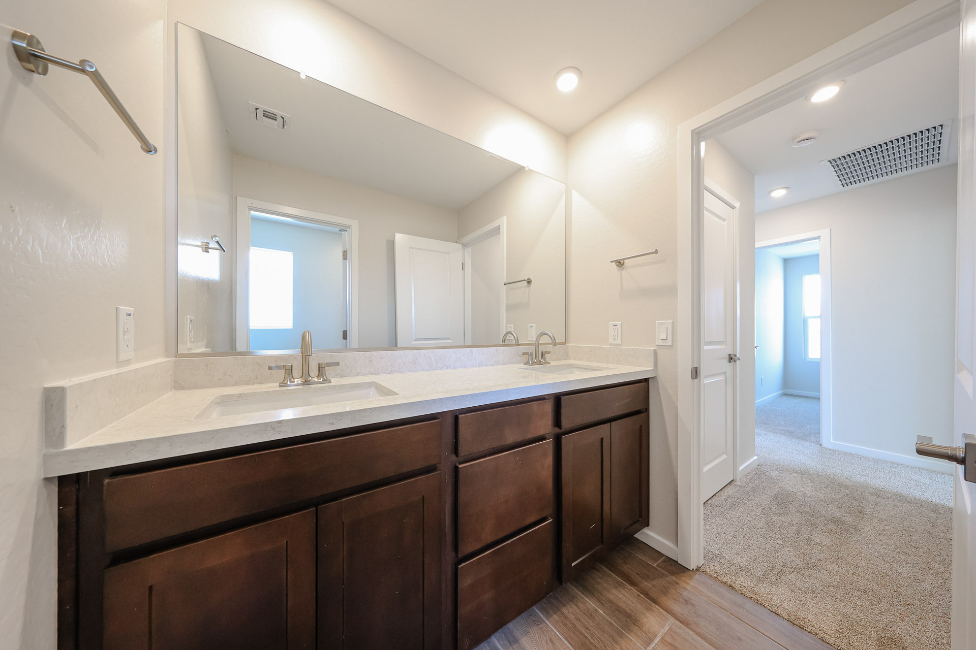 A bathroom with a large mirror.