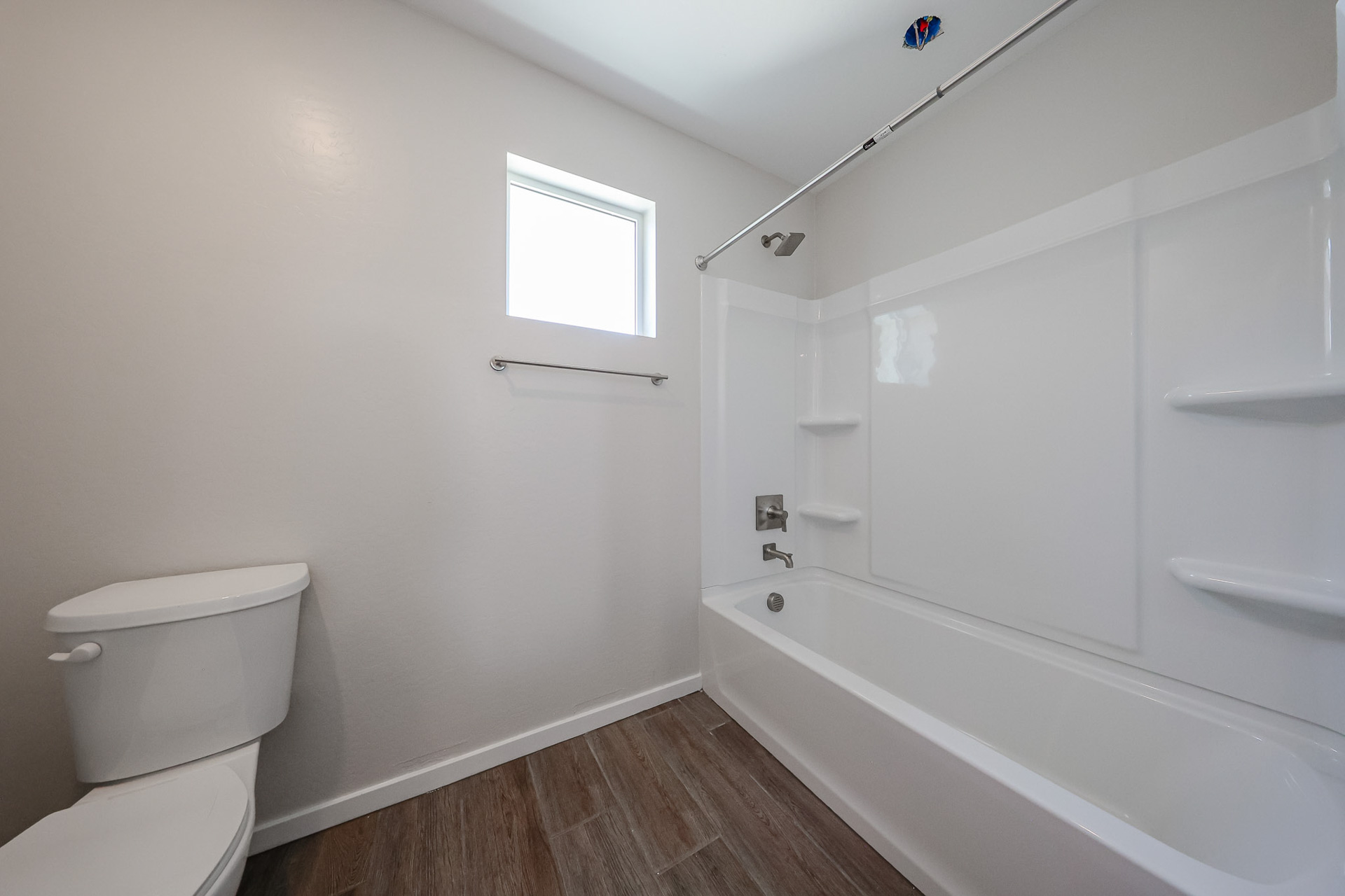A bathroom with a tub toilet and sink.