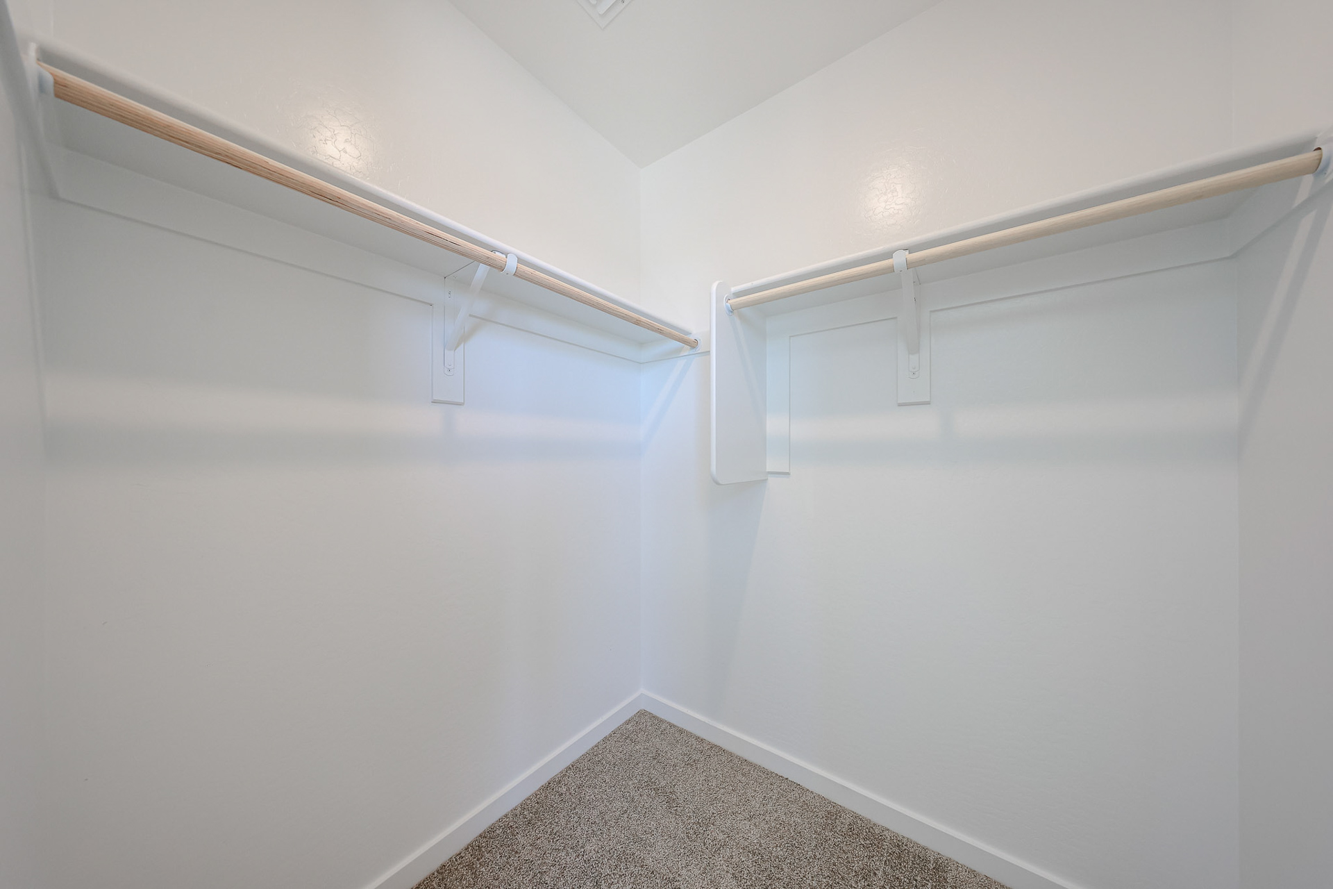 A white wall with a metal bar.