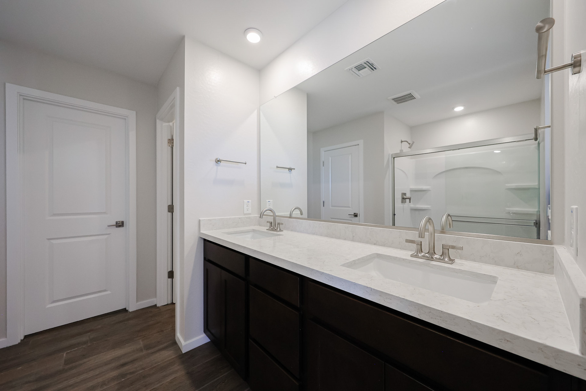A bathroom with a large mirror.