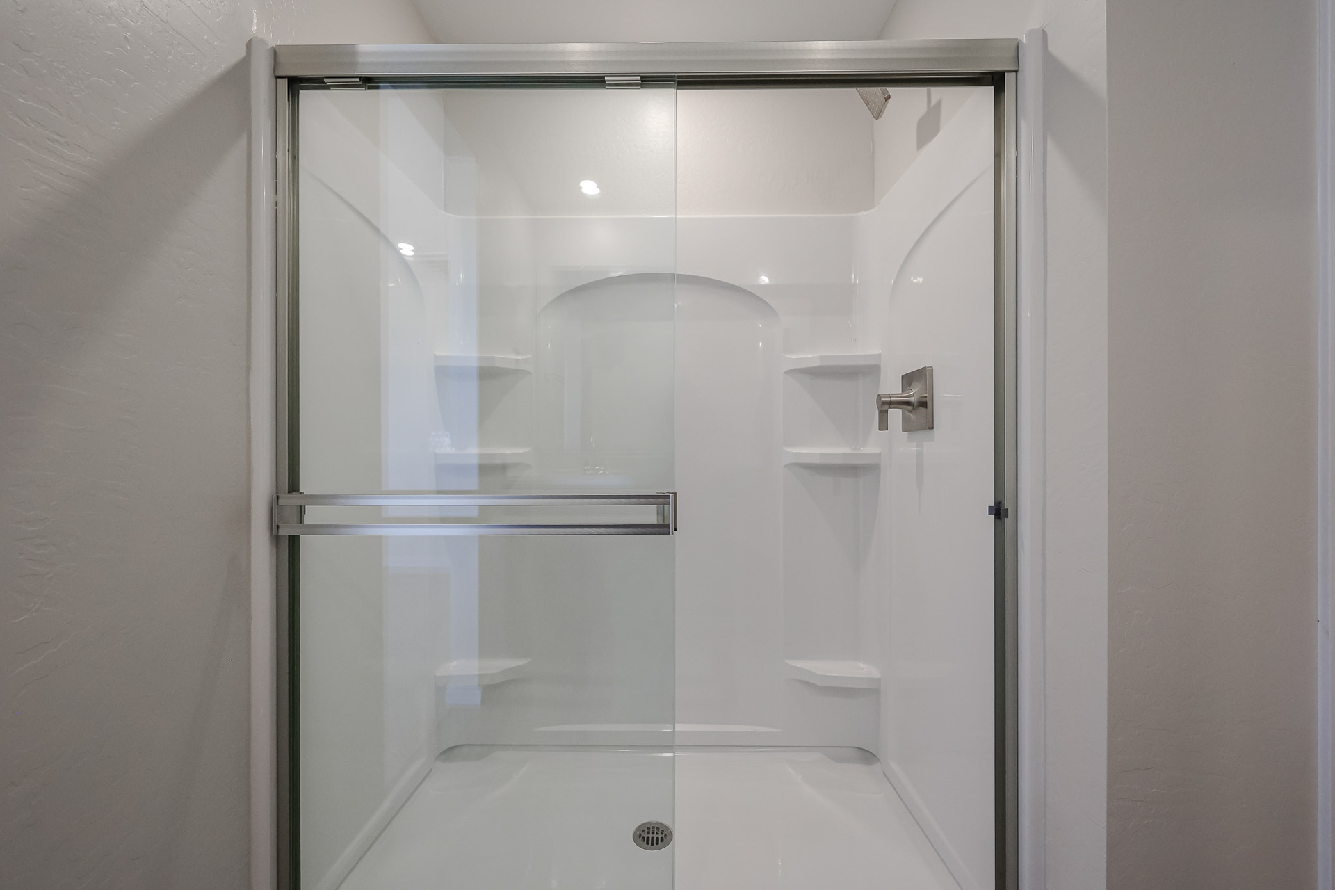 A glass shower with a glass door.