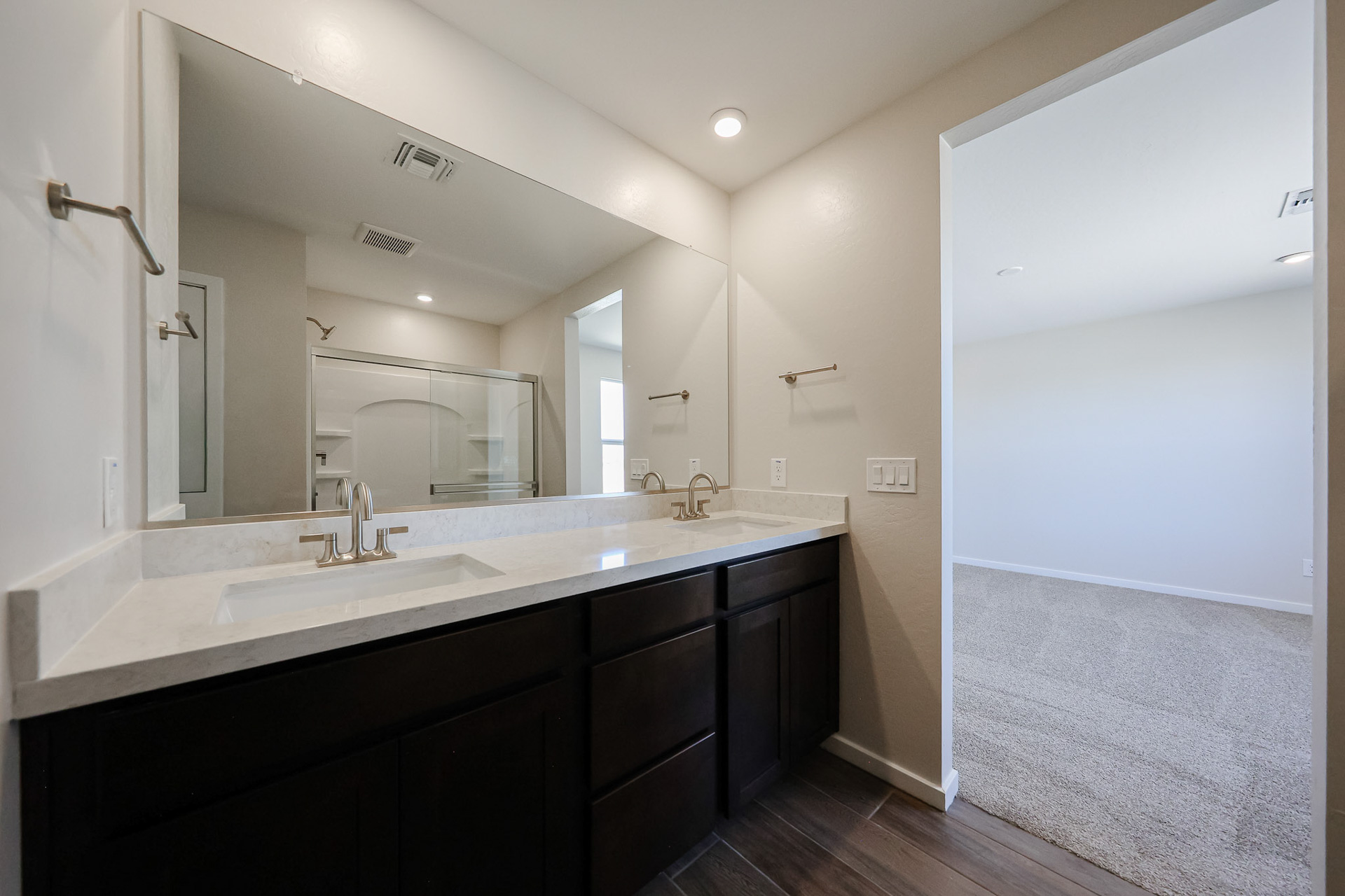 A bathroom with a large mirror.