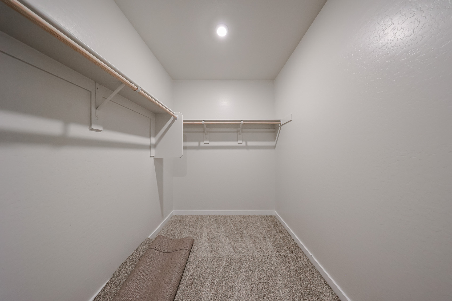 A room with a carpet and a rug.