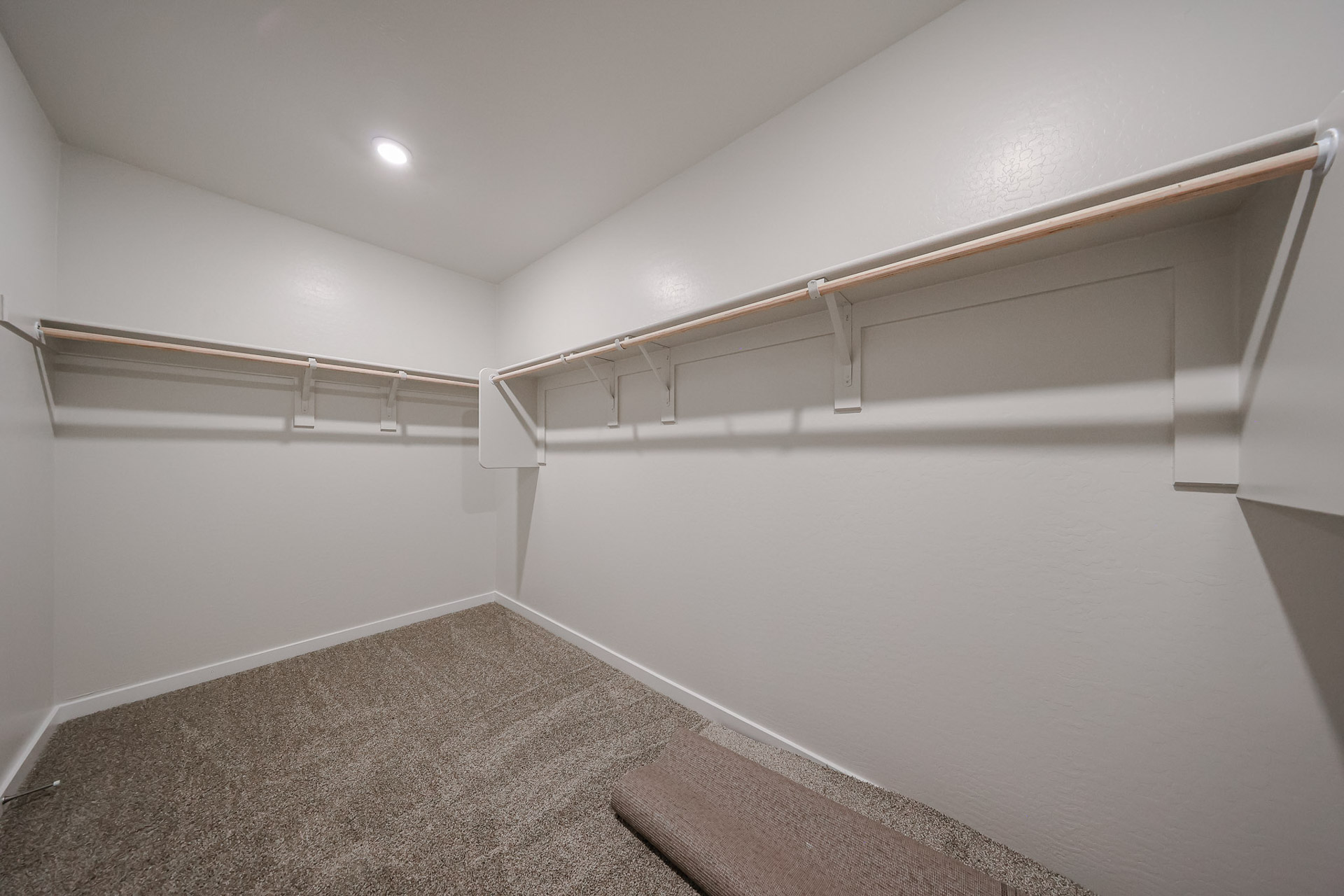 A white wall with a metal railing.