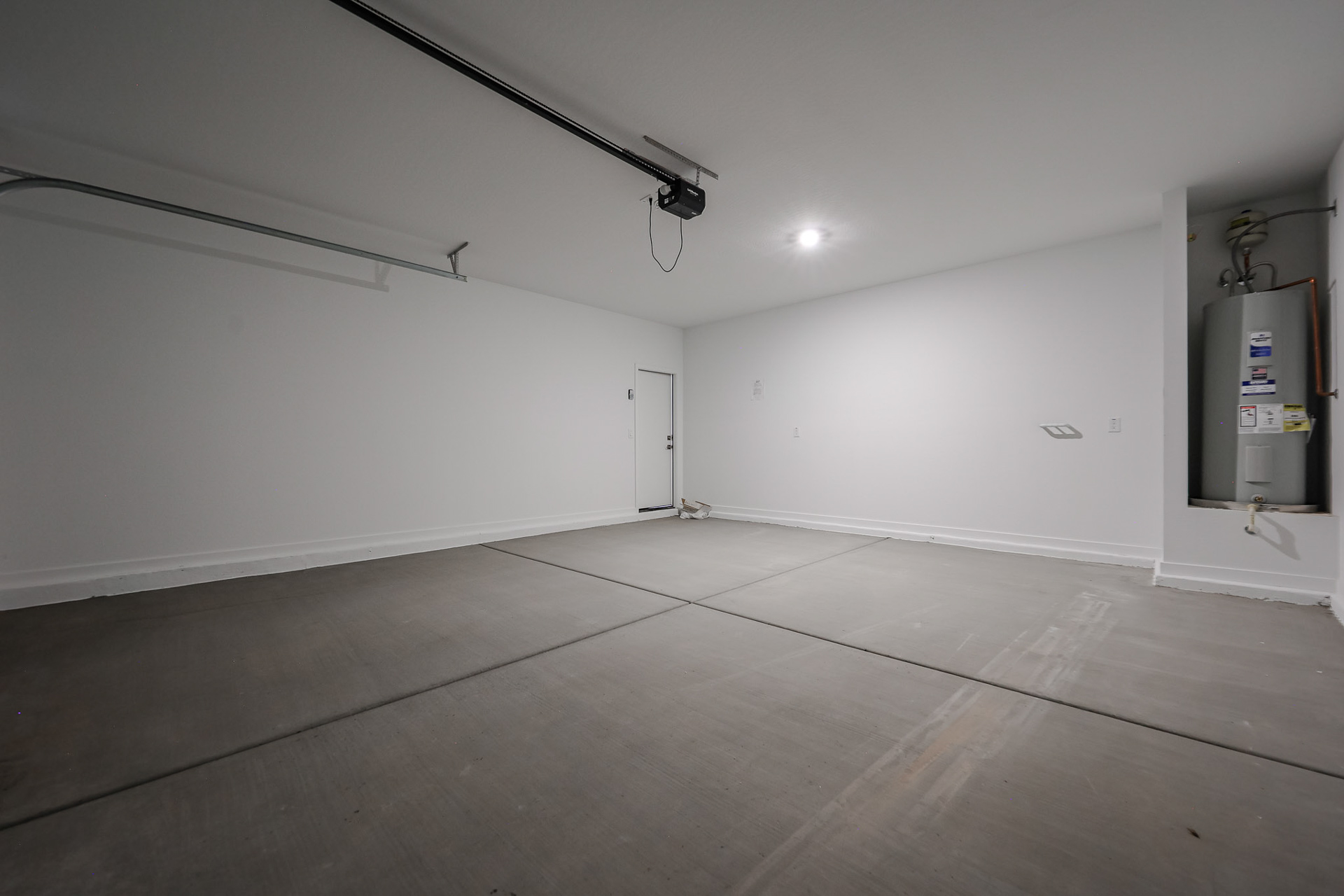 A room with a wood floor and a white wall.