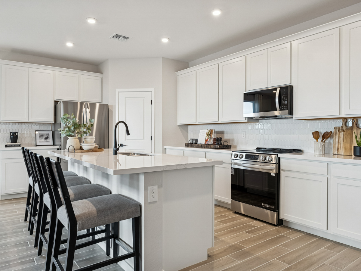 A kitchen with white cabinets.