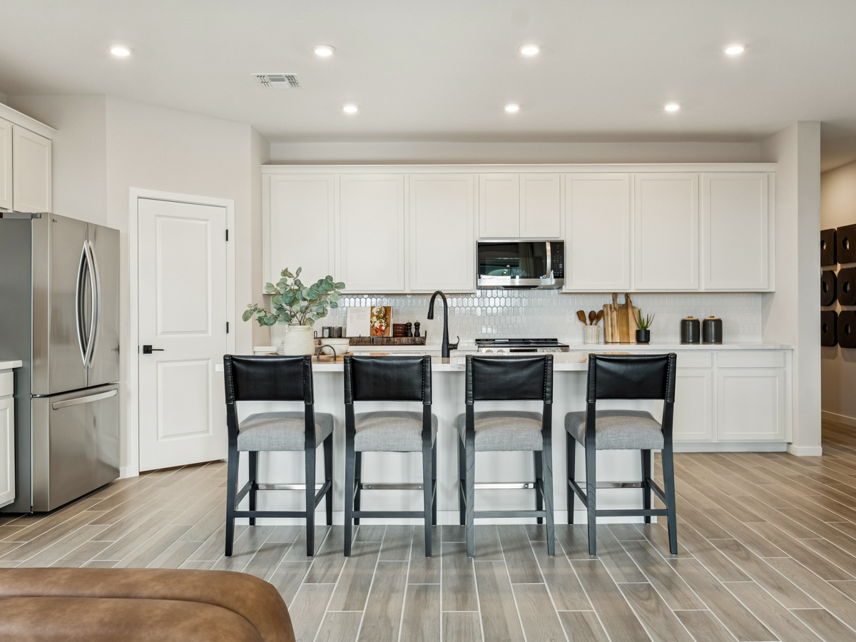 A kitchen with white cabinets.