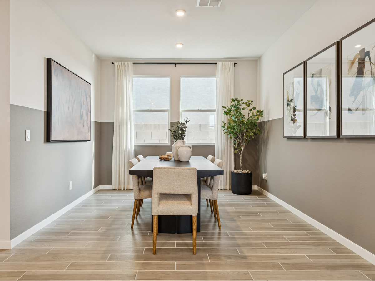 A dining room with a table and chairs.