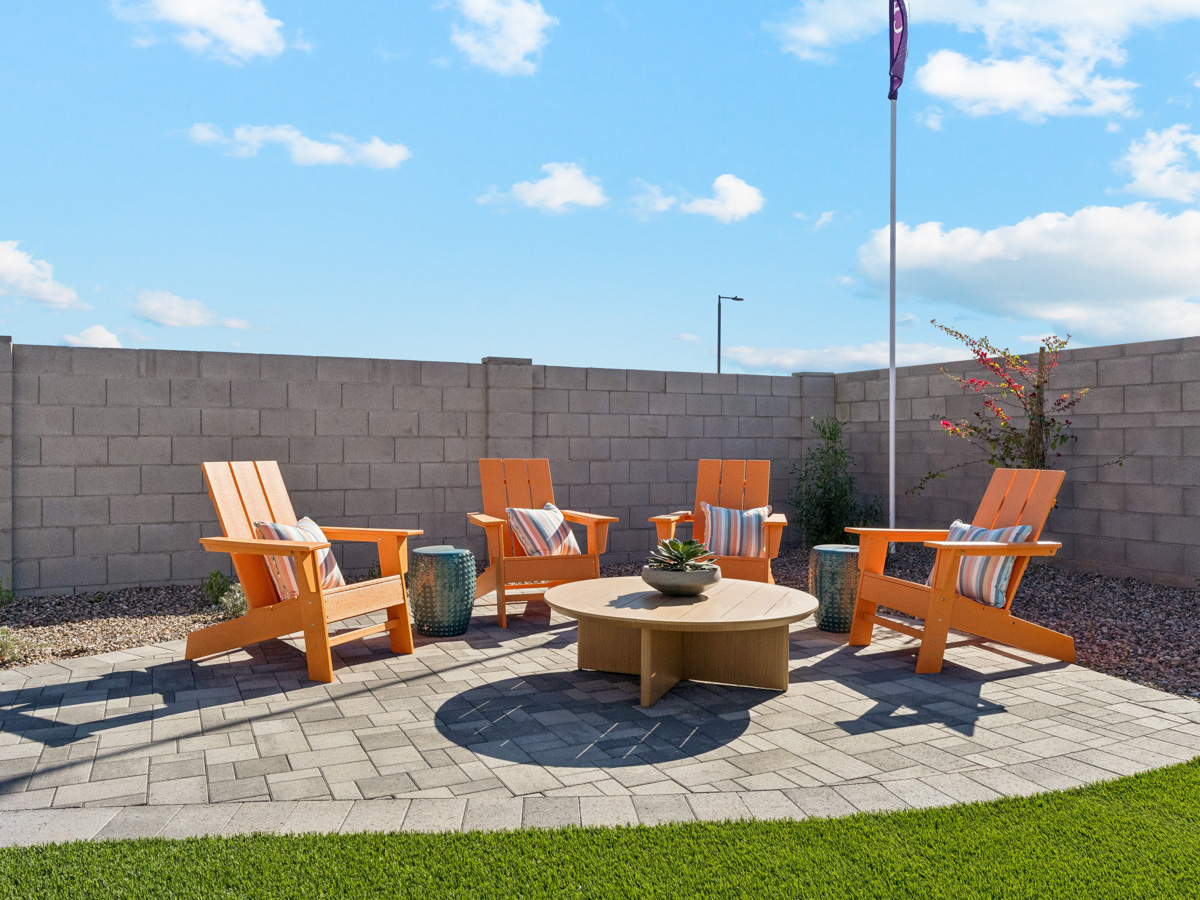 A group of chairs and a table outside.