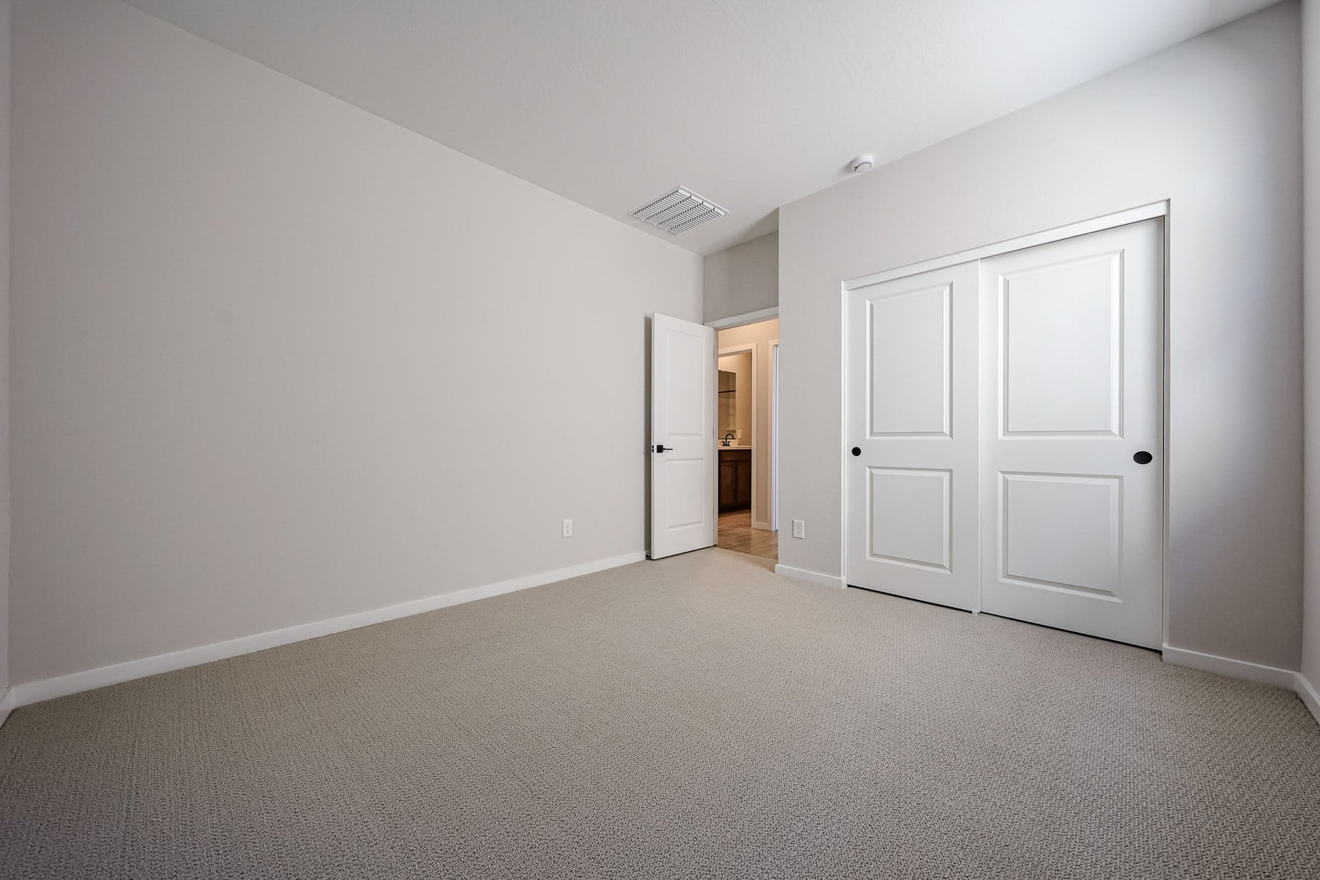 A hallway with white doors.