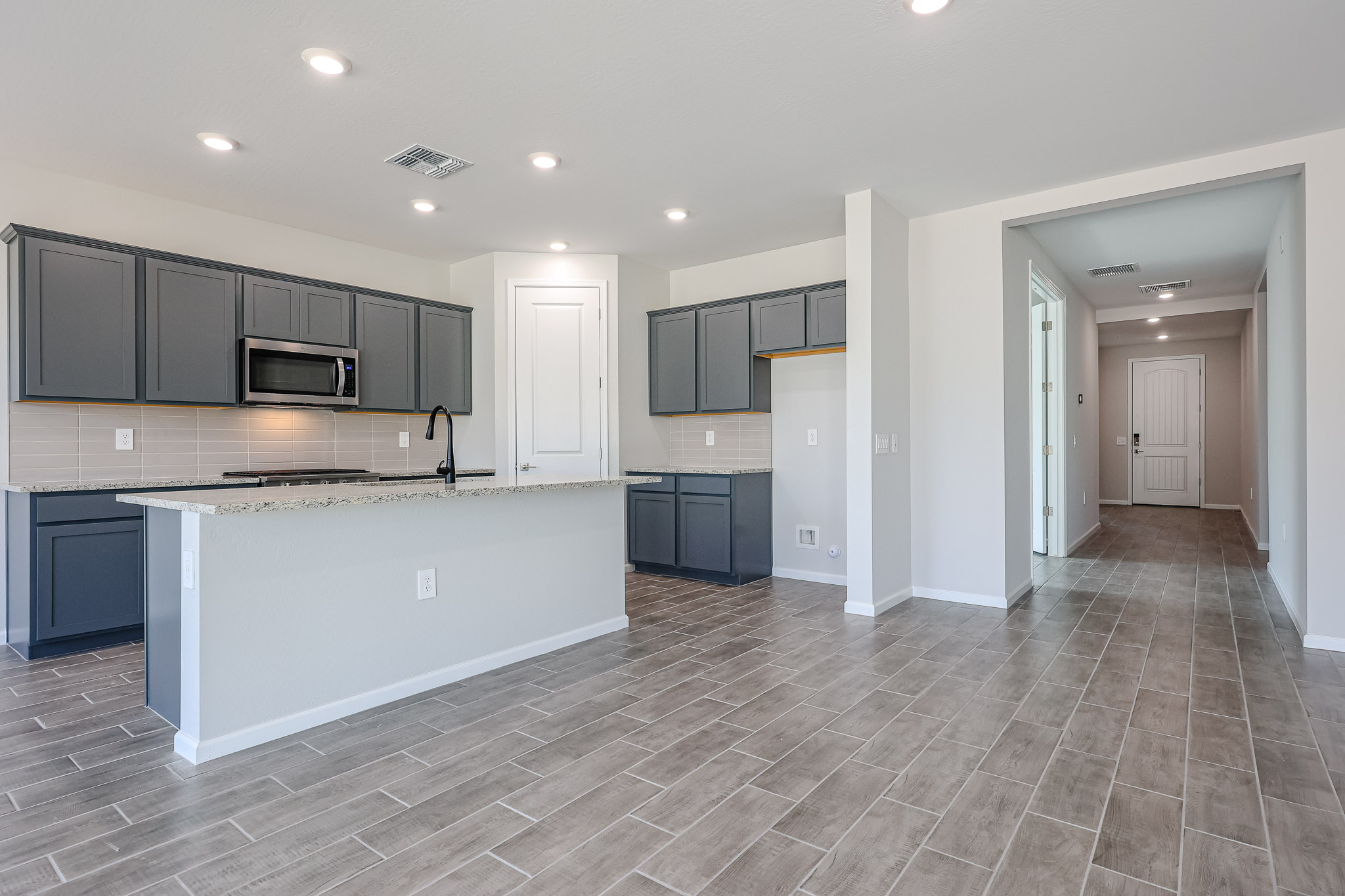 A kitchen with black cabinets.