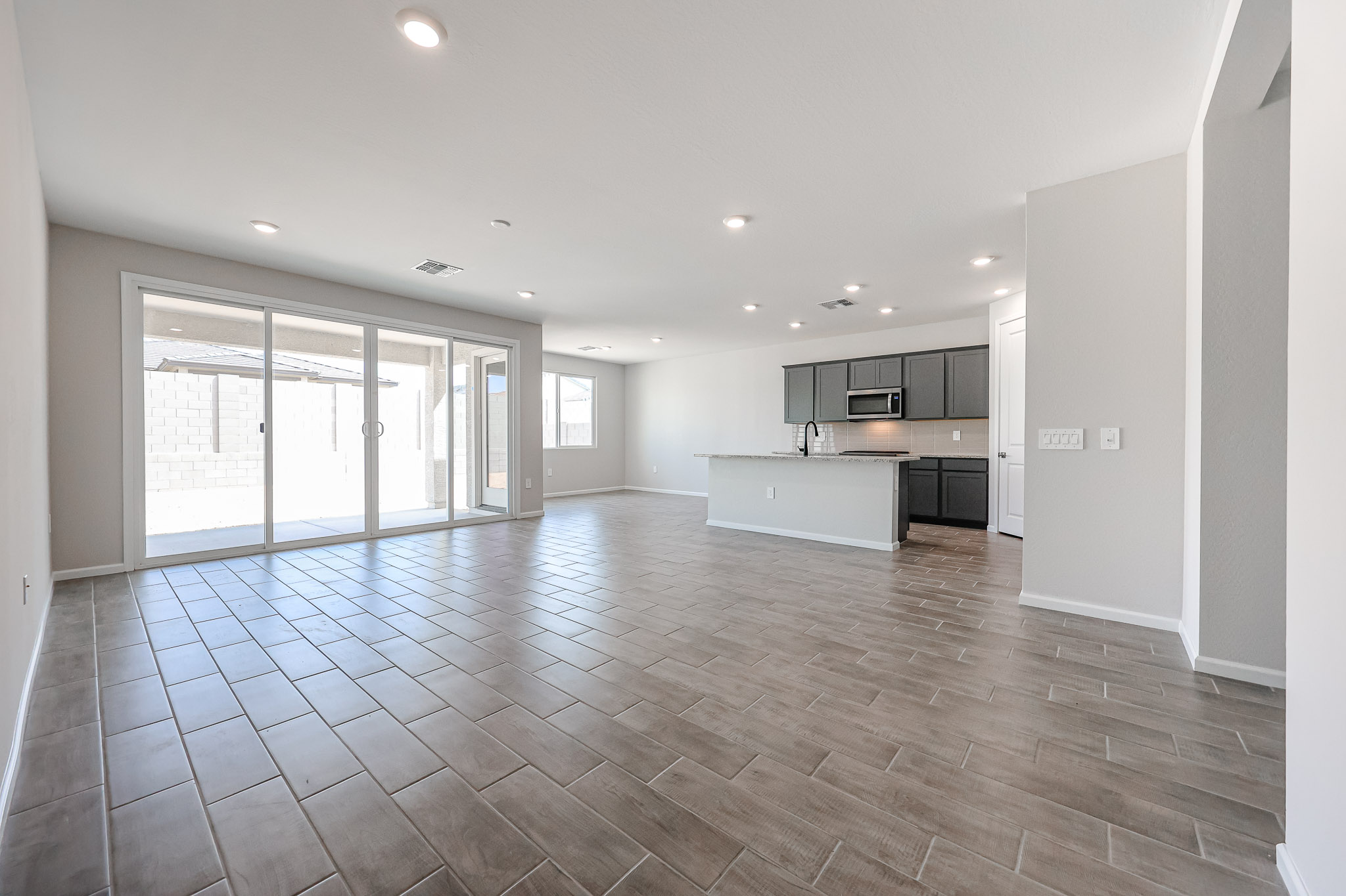 A large empty room with a wood floor and white walls.