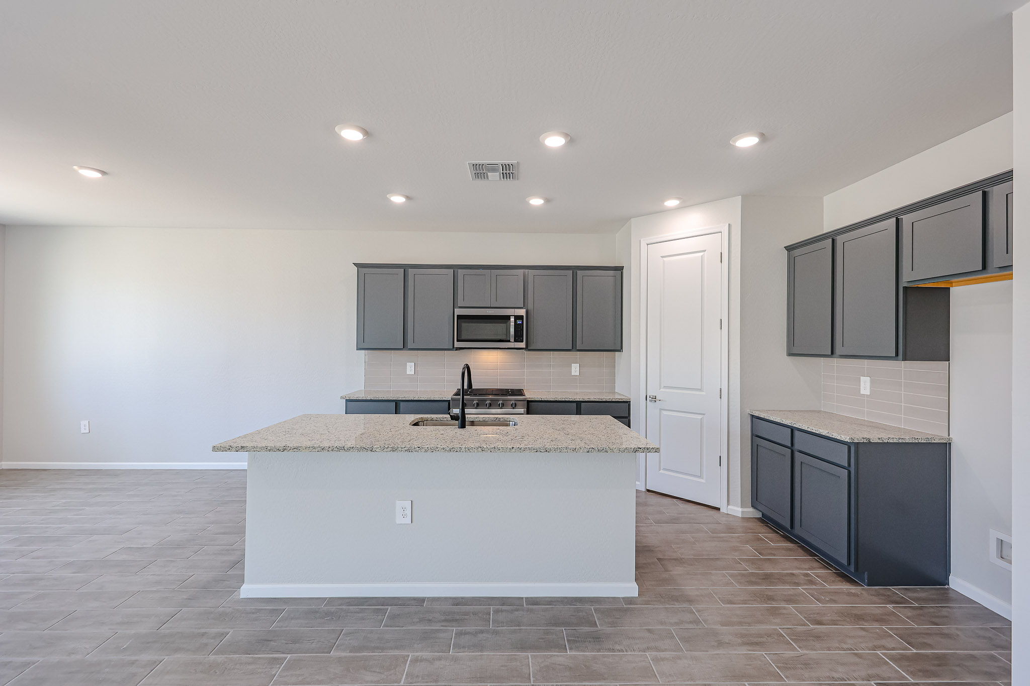 A kitchen with black cabinets.