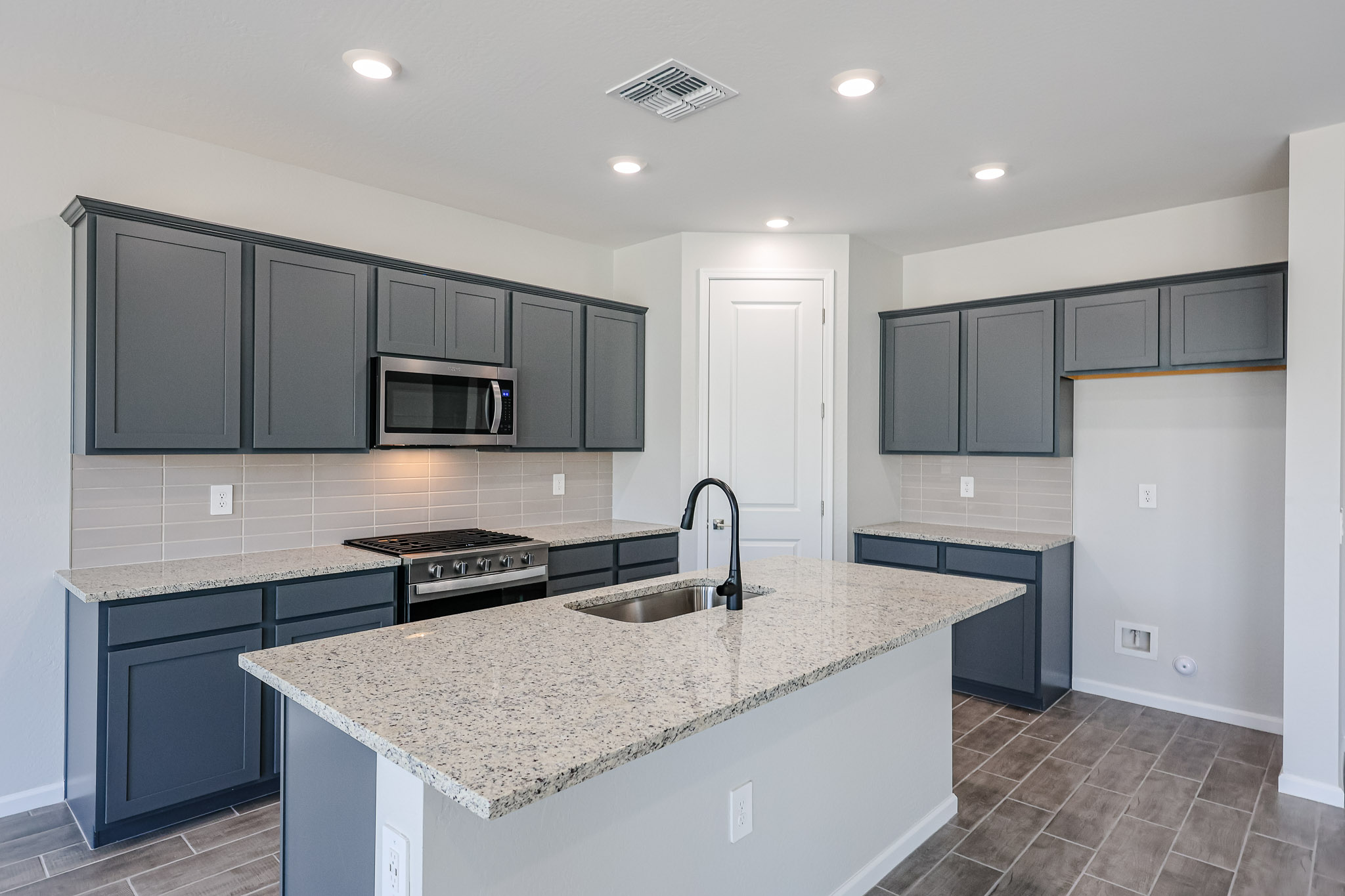 A kitchen with black cabinets.