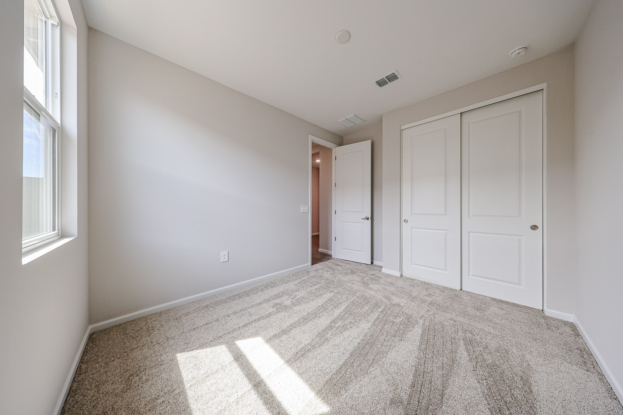 A hallway with white doors.