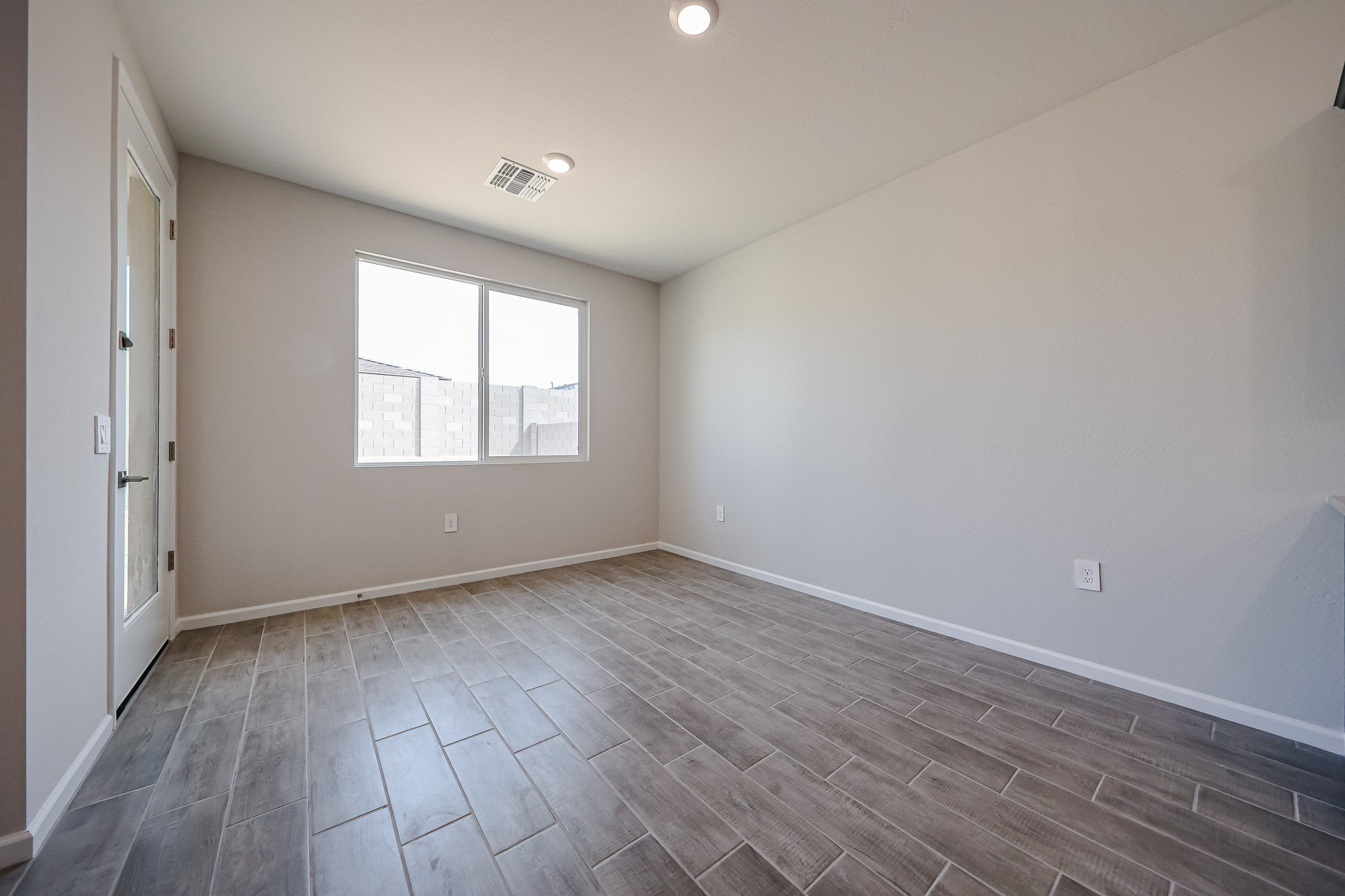 A room with a tile floor and a window.