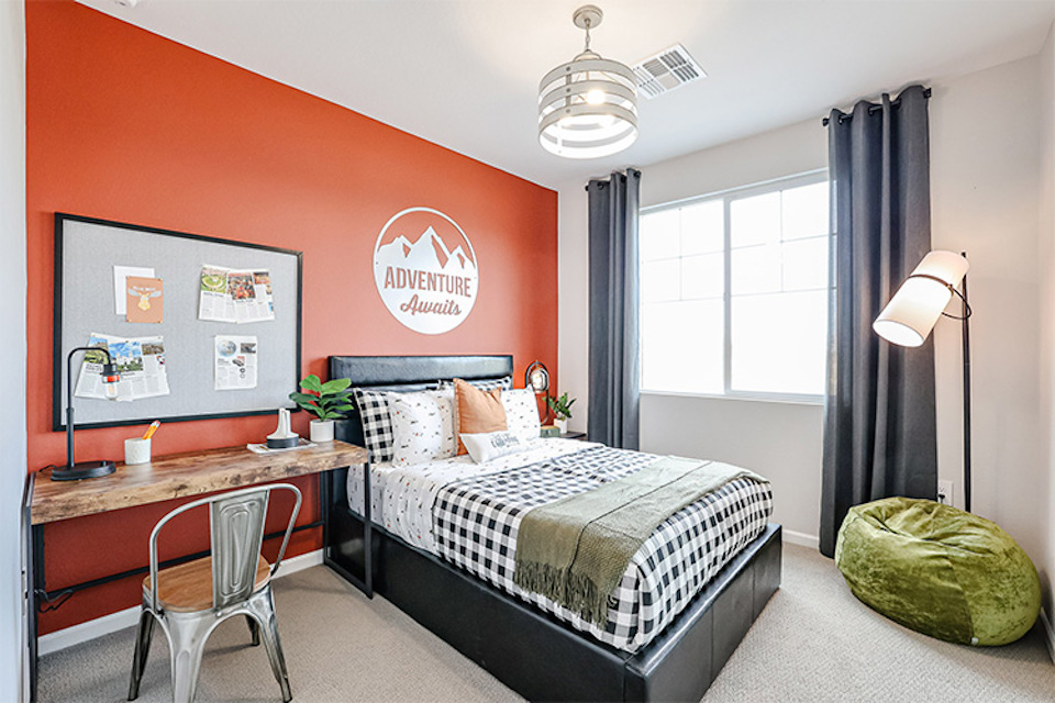 A bedroom with a bed and a desk.