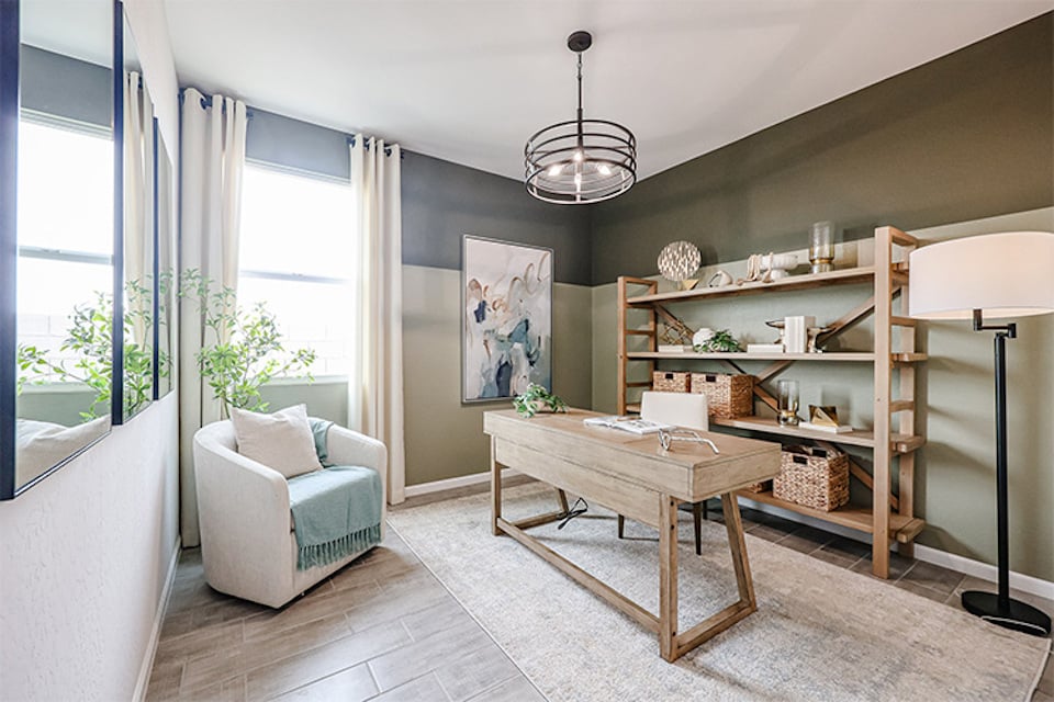 A living room with a table and shelves.