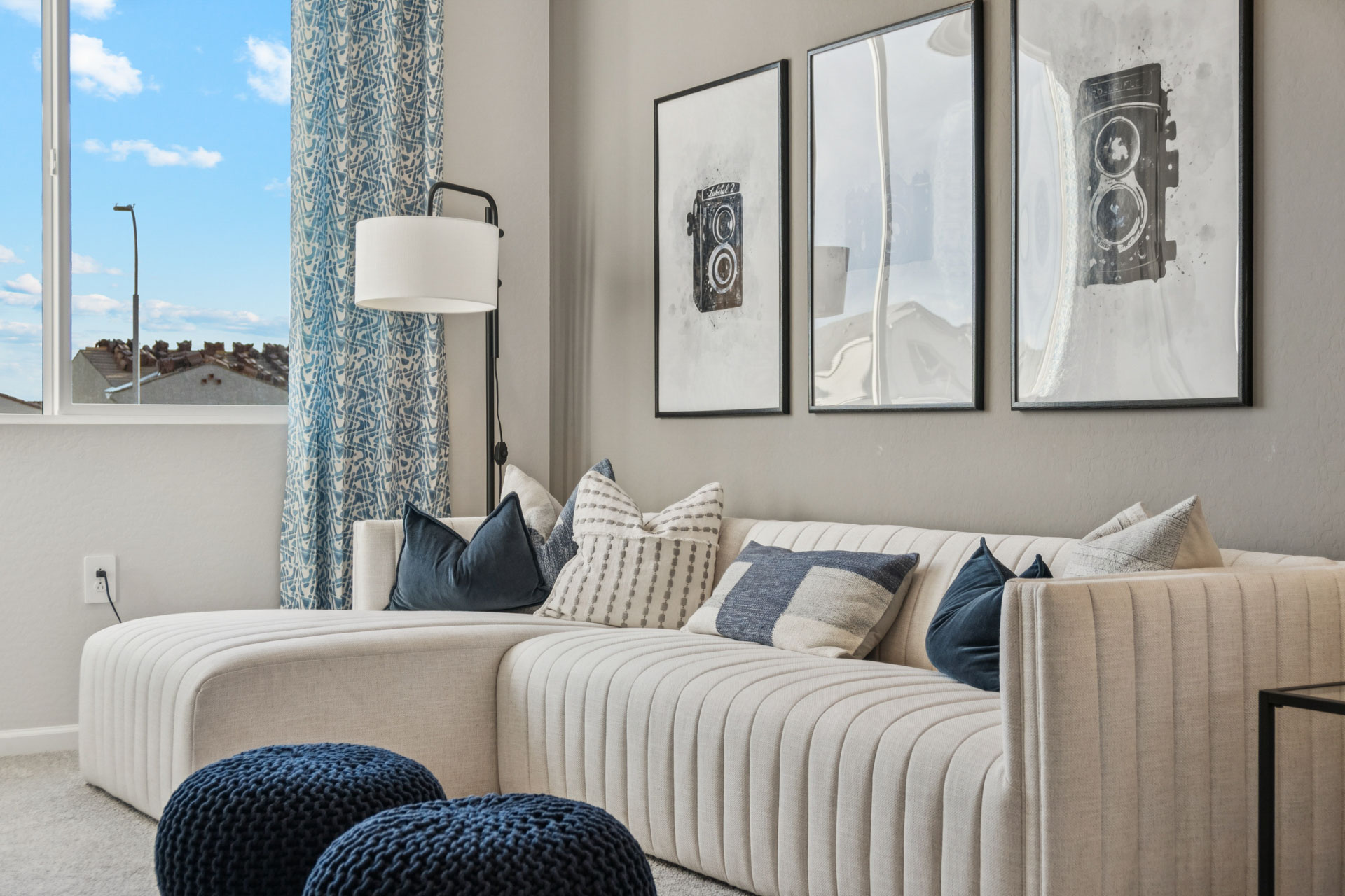 A living room with a couch and a lamp.