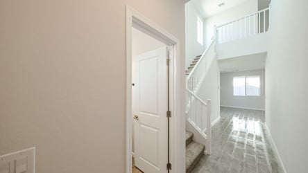 A hallway with white doors.