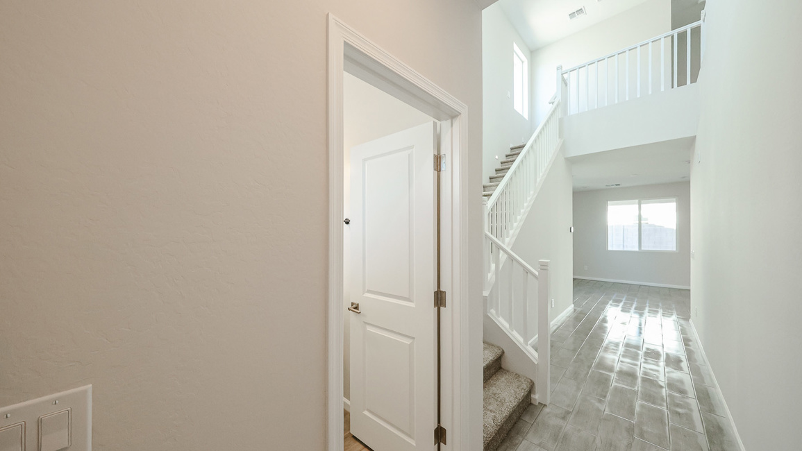 A hallway with white doors.