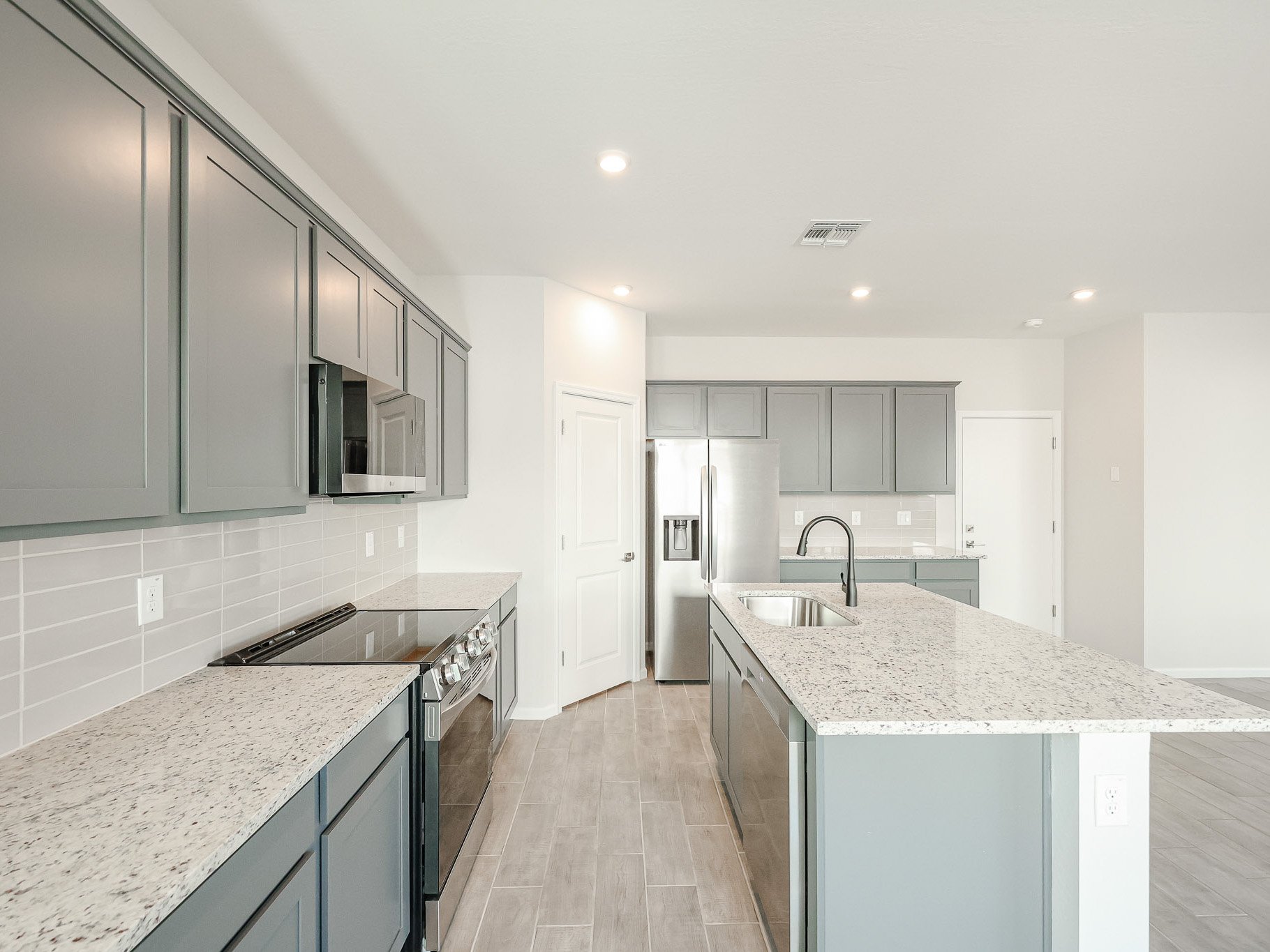 A kitchen with black cabinets.