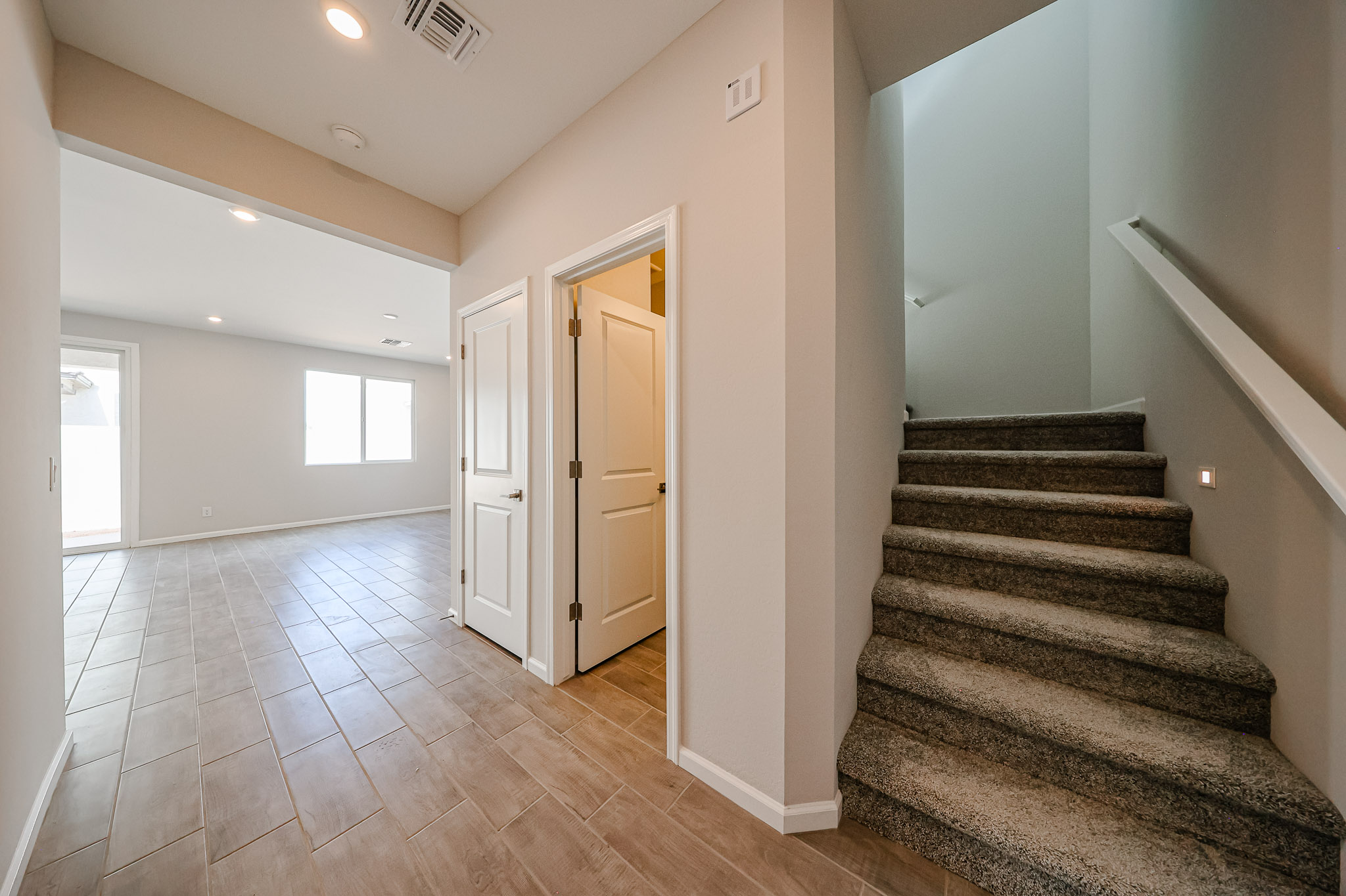 A long hallway with white walls.