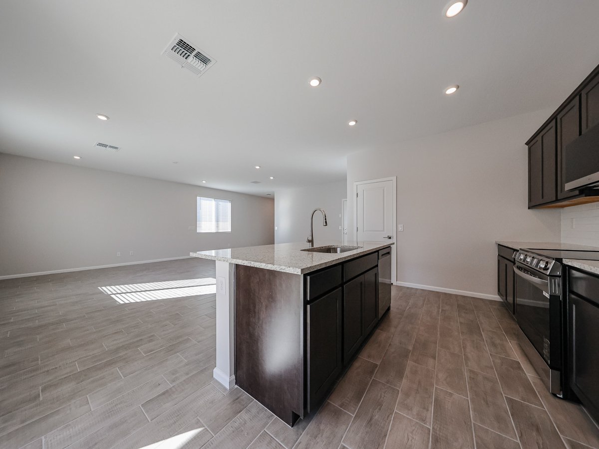 A kitchen with a wood floor.