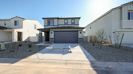 A driveway with a house in the background.