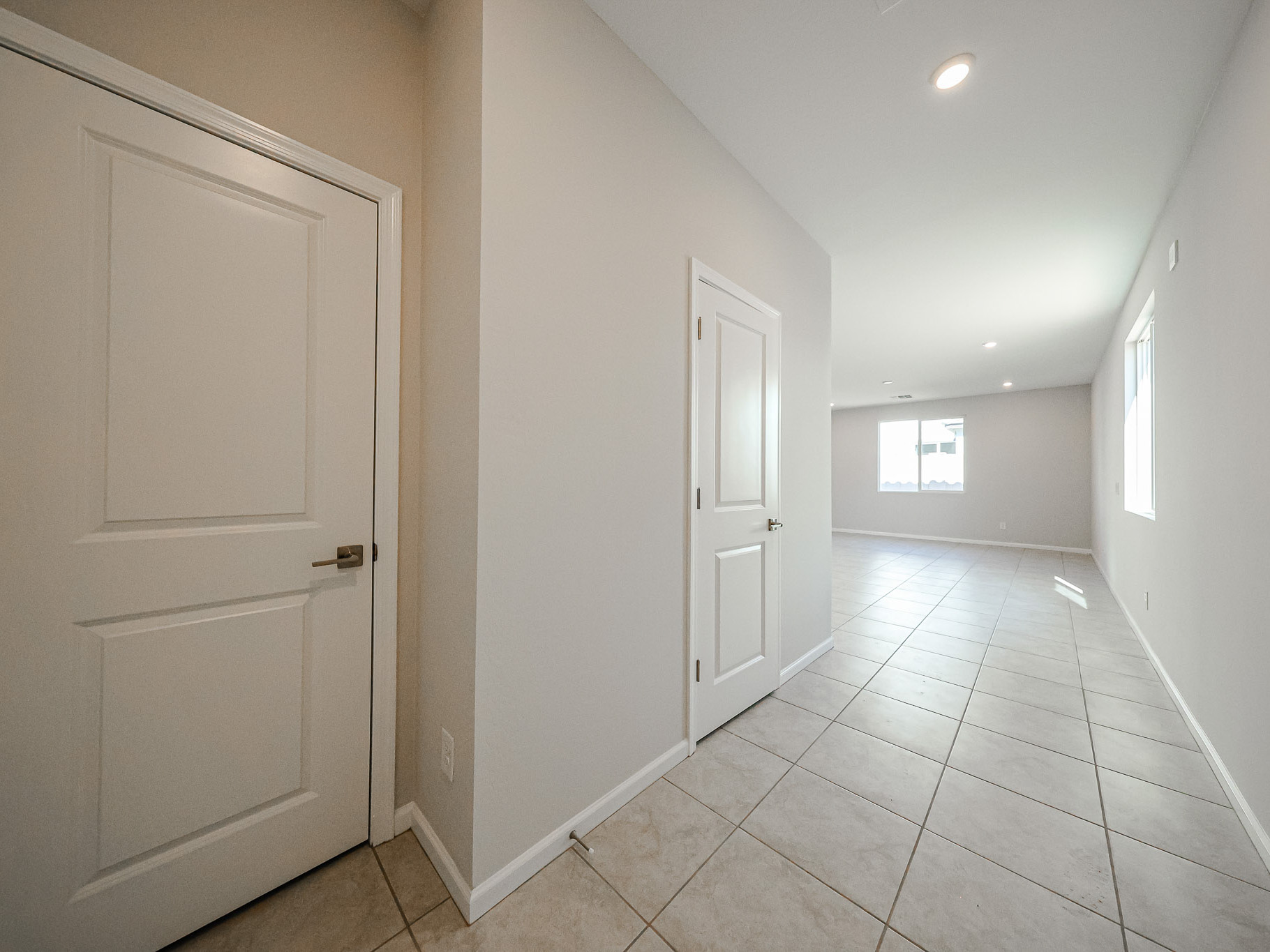 A hallway with white doors.