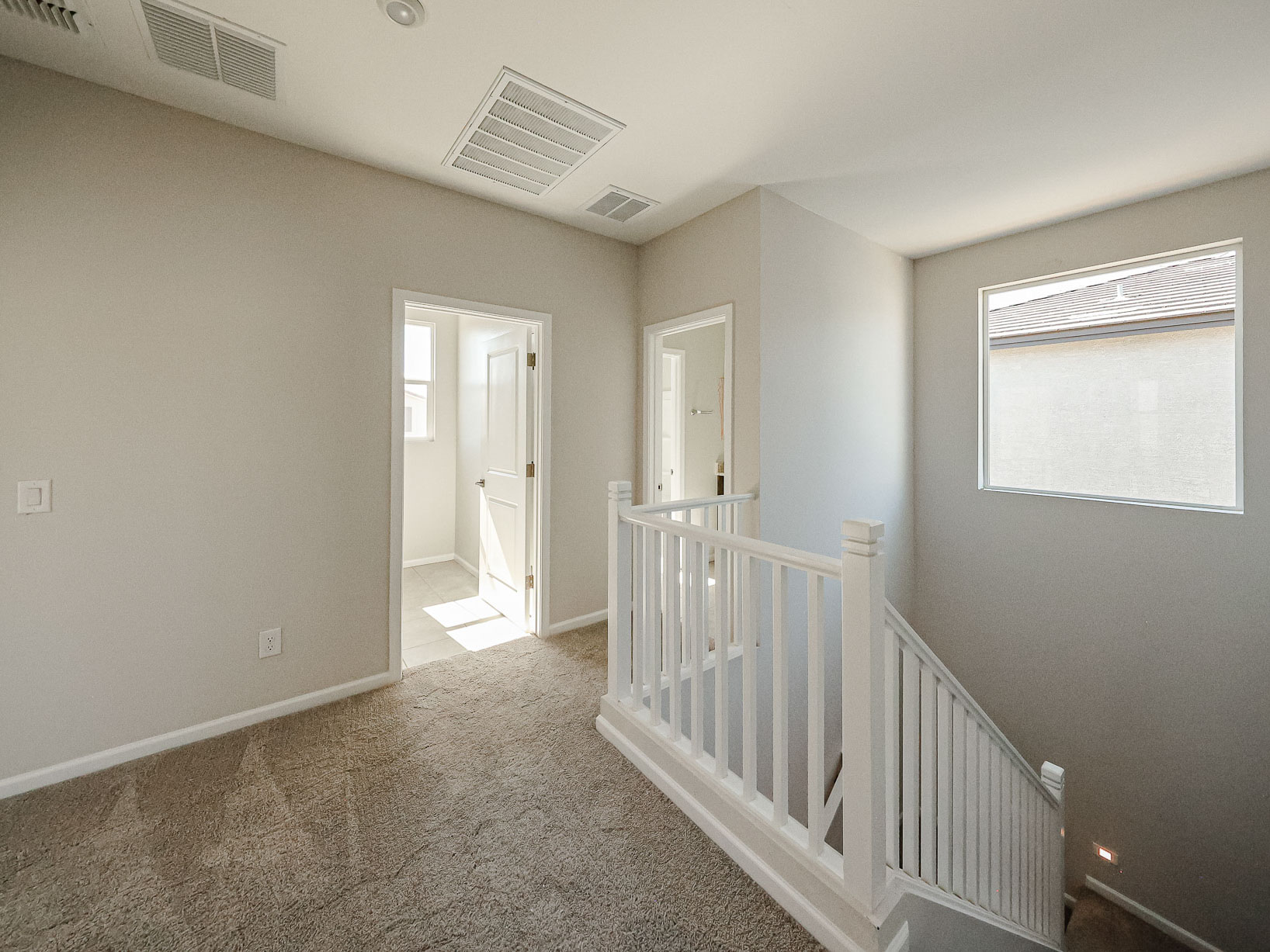 A hallway with white railings.
