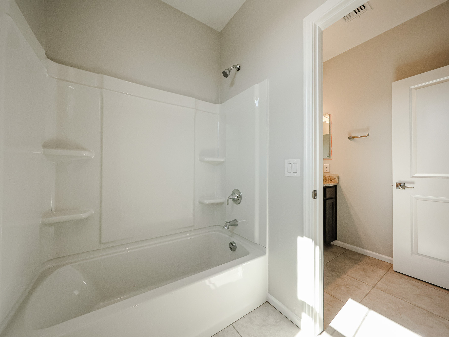 A bathroom with a tub and sink.