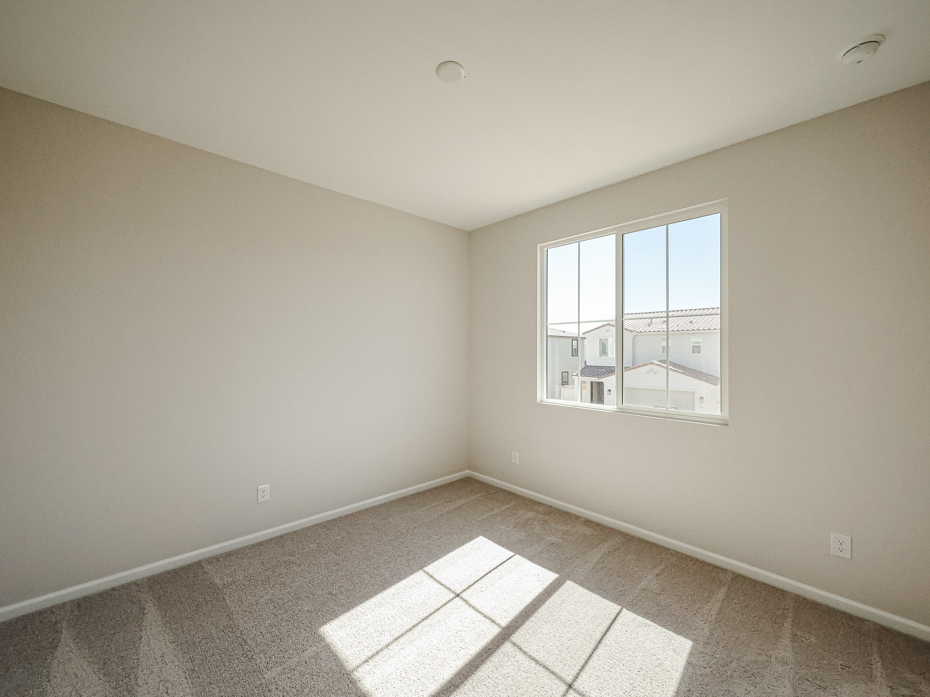 A room with a window and a tile floor.