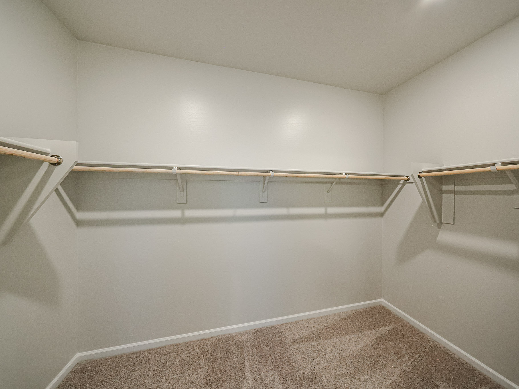 A white room with a metal bar.