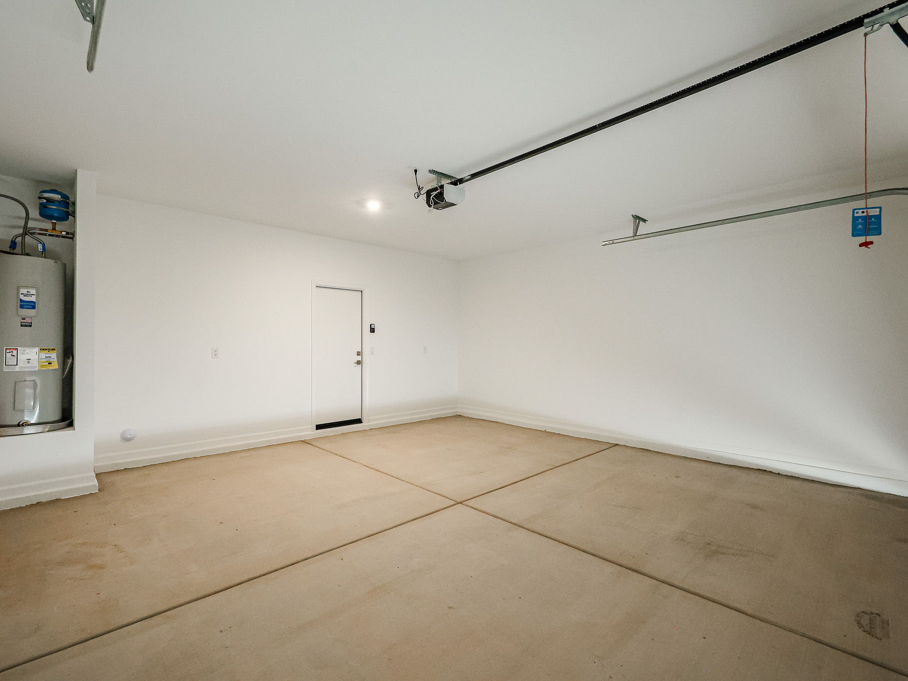 A room with a white wall and a wood floor.